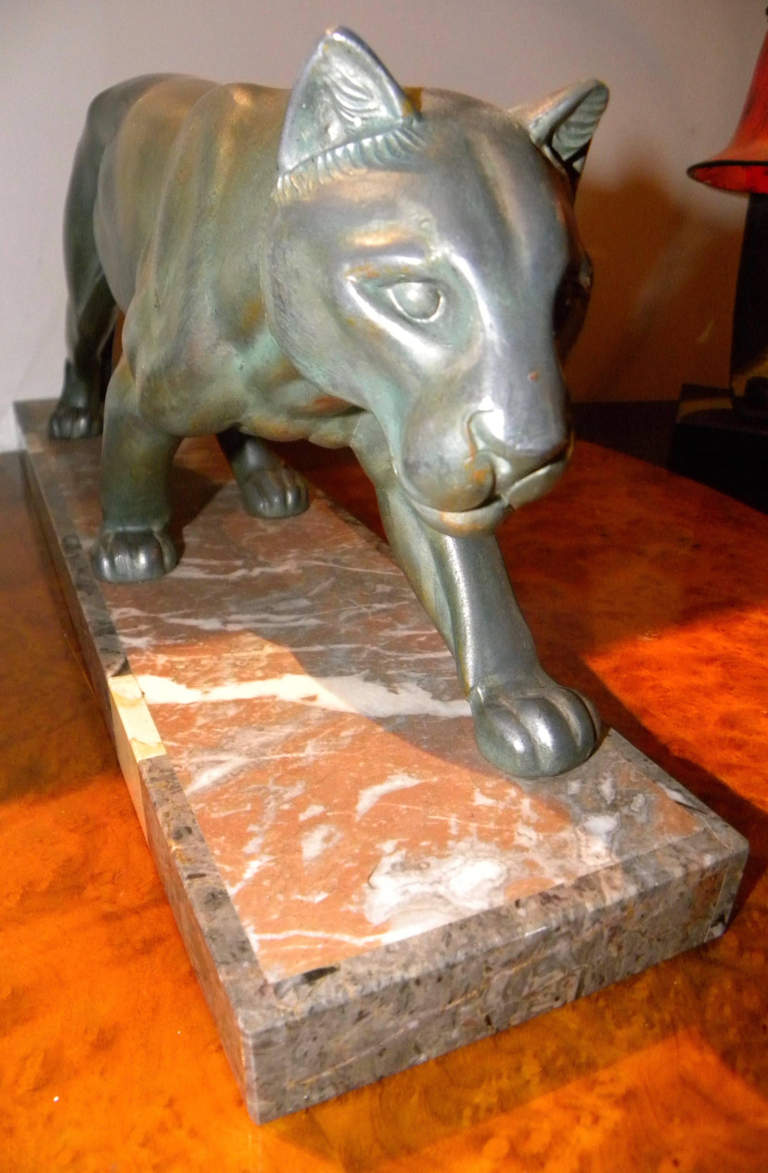 This prowling panther by M. Leduc (1879-1955), French Art Deco sculptor and artist. Classic design on detailed marble veneered base. Original design in perfect original condition with traditional green patina finish on a cast metal figure. Signed by