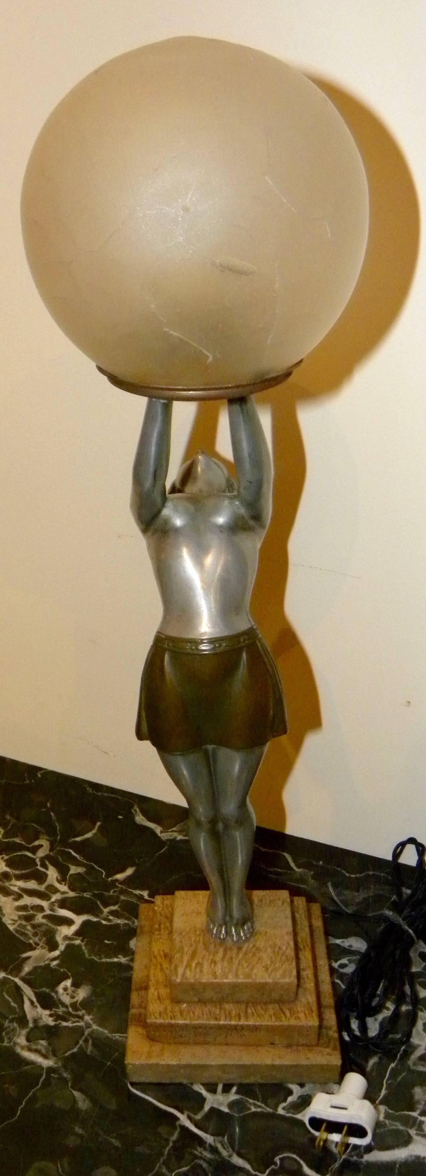 Here is a wonderfully unique statue or lamp combination. It is done in cold painted cast metal patinated and all original. The lamp is signed Balleste on the foot of the woman. Very much in the tradition of the famous Max Le Verrier Clarte figurine.