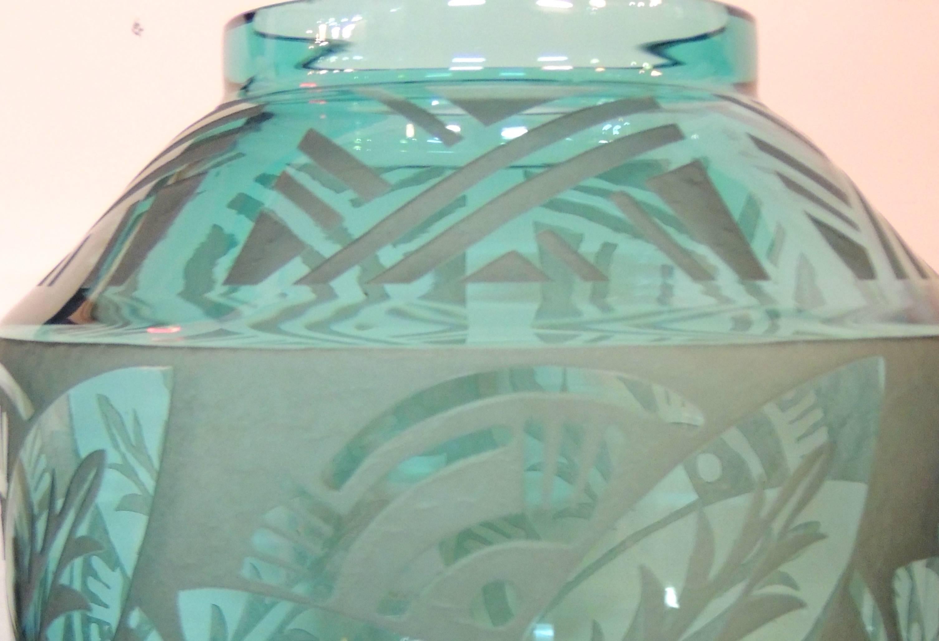 This turquoise Daum vase has an Art Deco etched design on glass of a most unusual color and clarity. The modernist tropical motif would fit in well in a South Beach apartment or a contemporary condo. It bears the signature of one of the most famed
