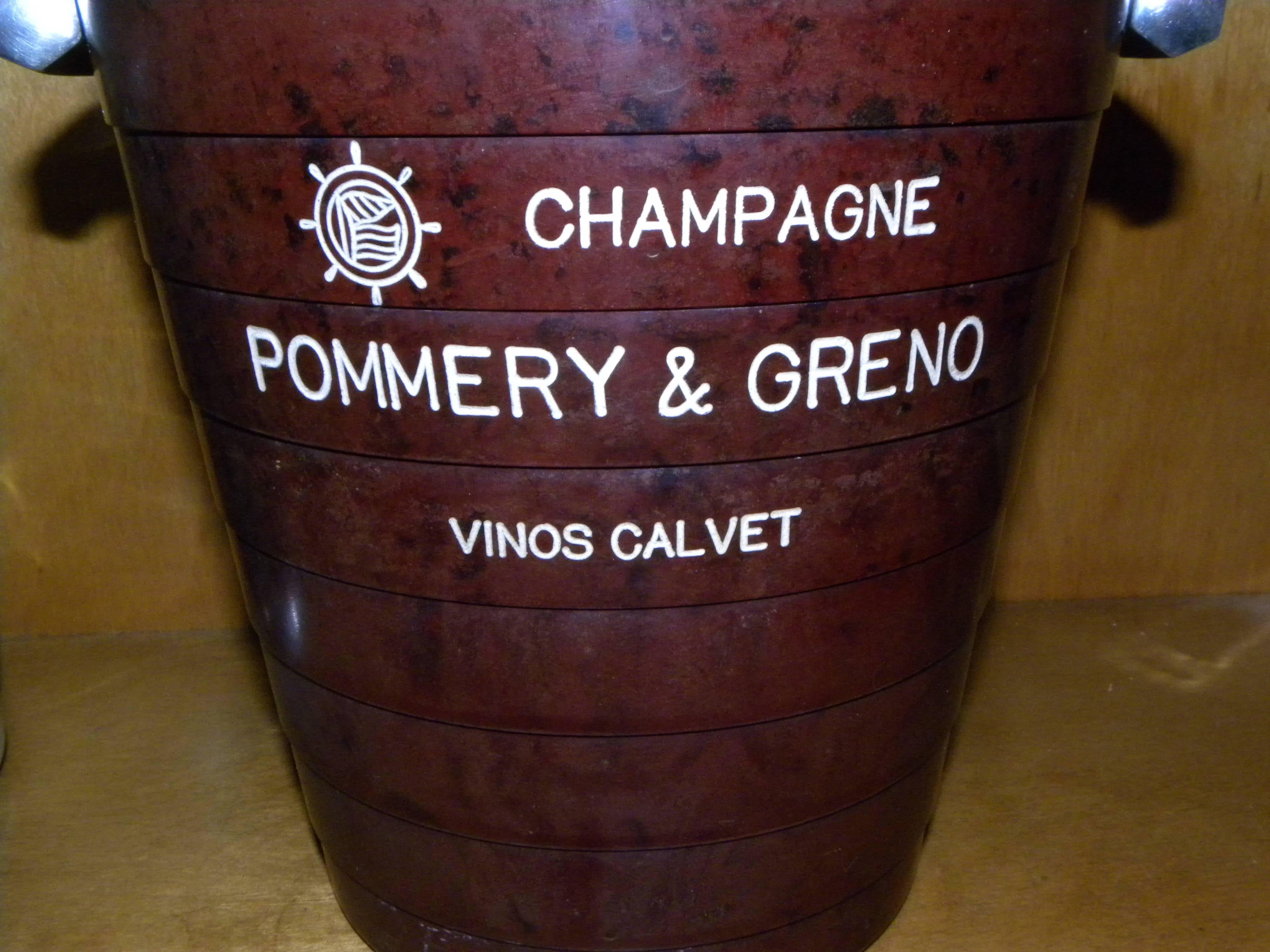 Extremely rare French marbled brown Bakelite stepped champagne bucket. This is a highly collectible piece, with an original advertisement for “Pommery & Greno” Calvet on one side and Reims on the other. The upper rim and handles are detailed