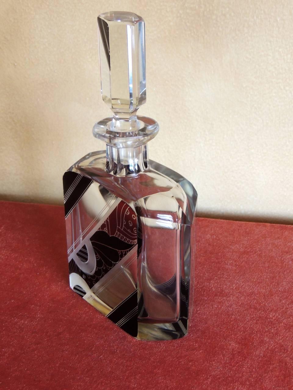 This marvelous decanter can be attributed to Karl Palda, a designer of Czech crystal pieces with a distinct style that was modernist, jazzy and ahead of its time! Heavy, leaded crystal, beautifully cut and bearing an almost quirky asymmetrical