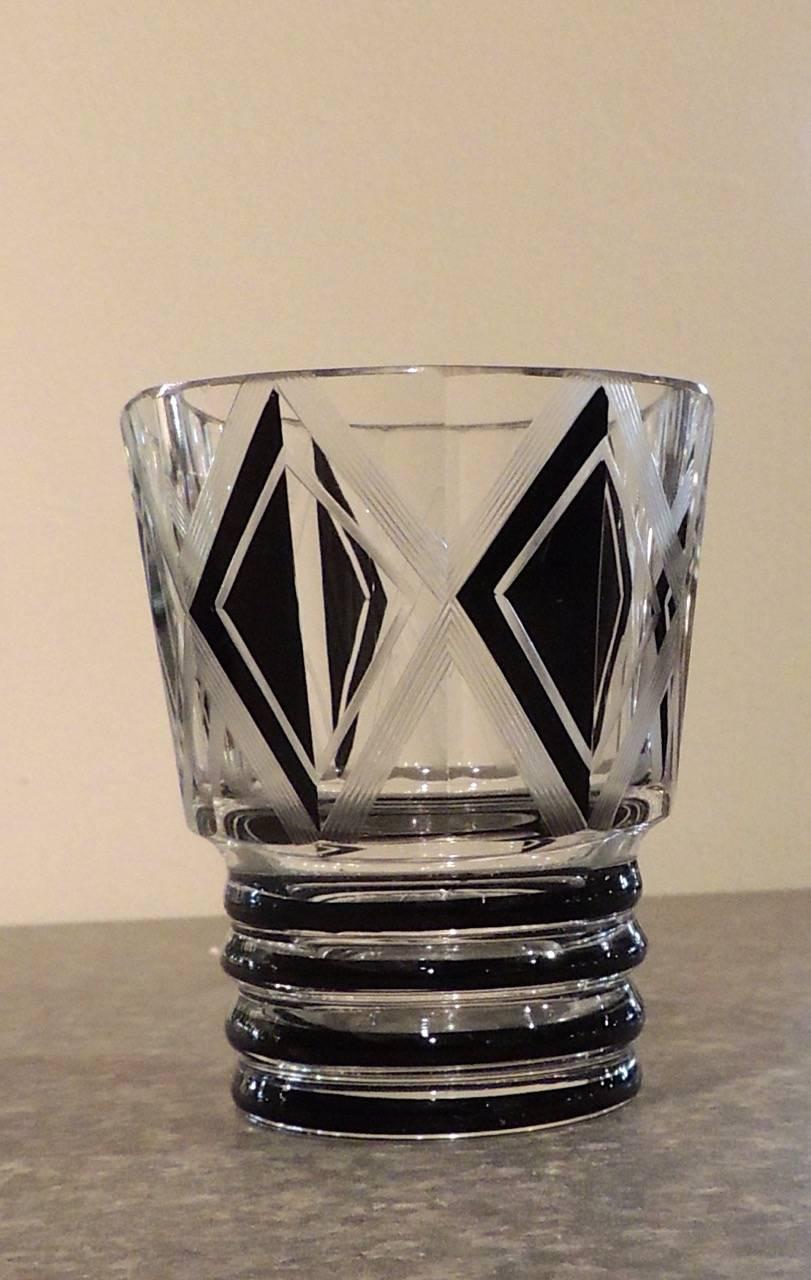Czech decanter and five matching glasses in a geometric Art Deco design. The ring pattern is repeated on the decanter, made of heavy Bohemian crystal and is matched by glasses of a size more substantial than most of these sets that have tiny cups