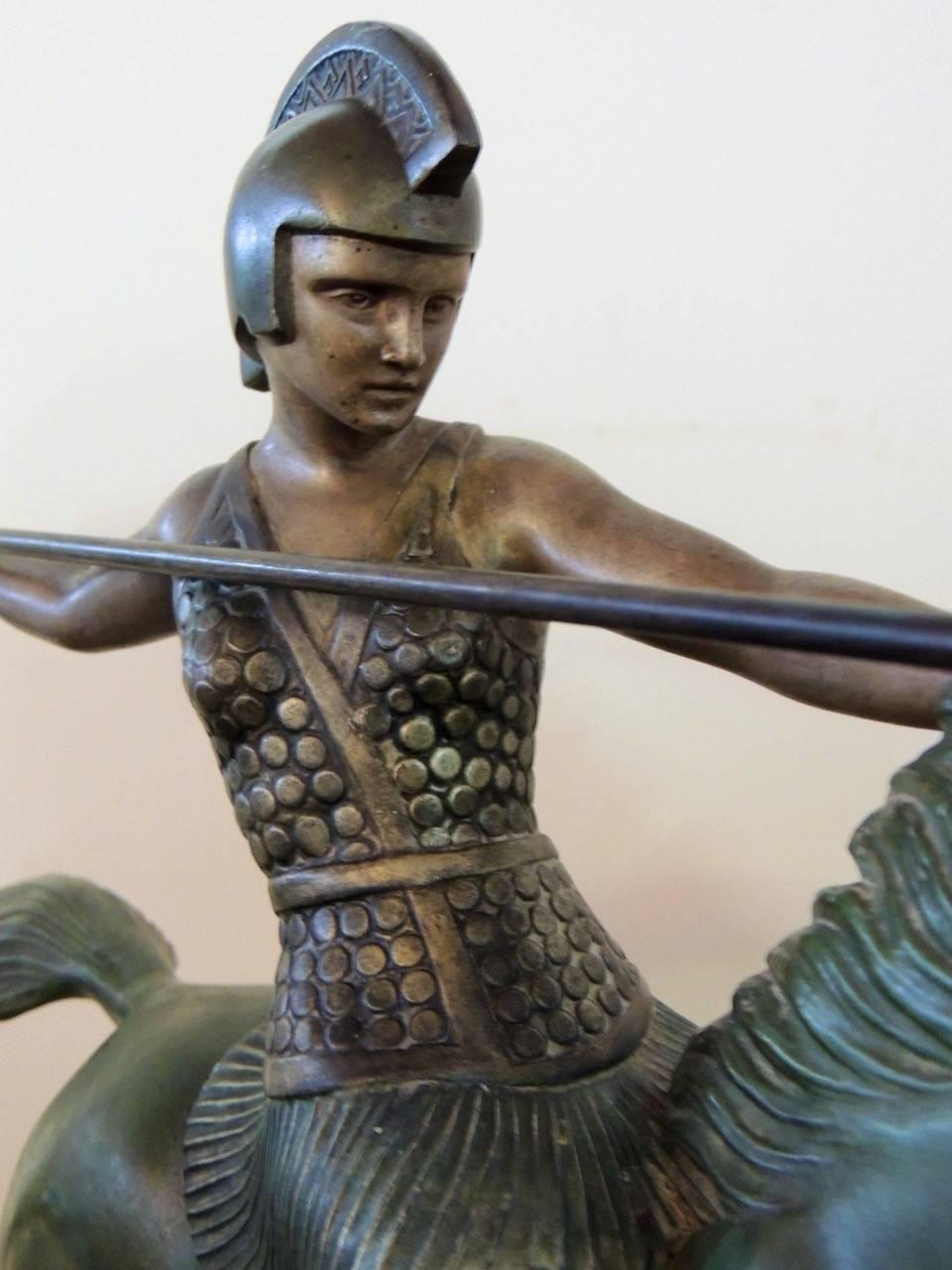 A beautifully executed Art Deco sculpture of a woman warrior in cold painted metal with a rich patina green base and touches of gilding. The piece is signed by Melo, a sculptor known for equestrian themes in his art and statues of the