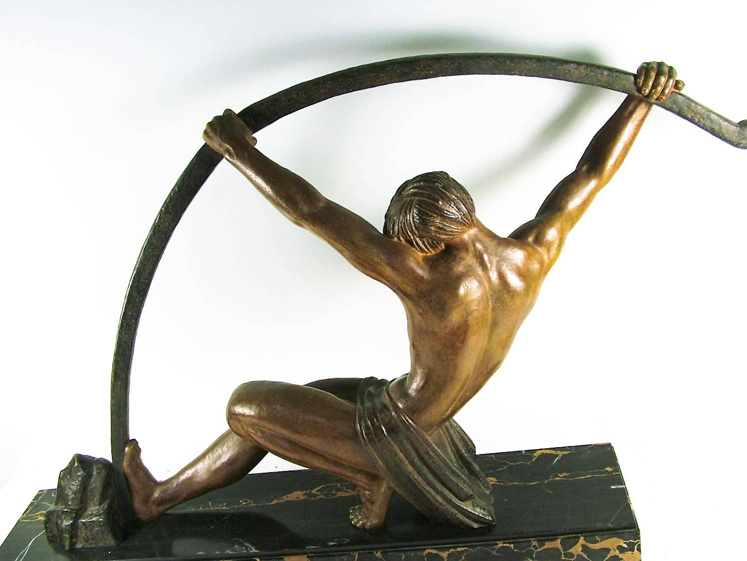 “L’Age du Bronze” sculpture by Demetre Chiparus, a powerful French spelter statue is sometimes referred to as the famous ” bending bar man”  It was made in two sizes and  this one, much more rare, is the larger size of 34 ” X 6.5″ D X 21″ T, the