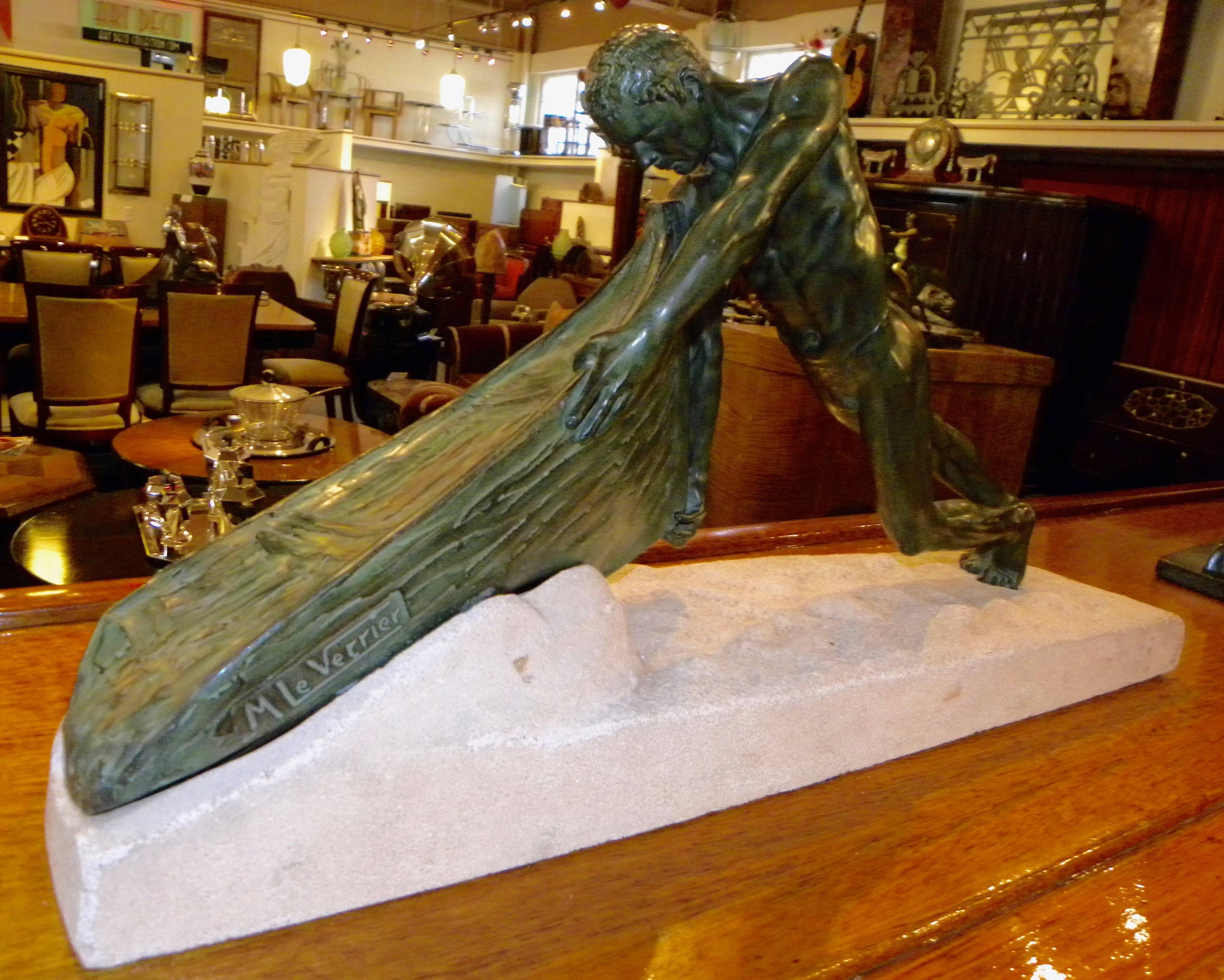 An Art Deco Sculpture showing great strength in a depiction of a man pulling his row boat from the sand. This striking work done and signed by Max Le Verrier in the late 1920s France is especially dynamic.

Notice the musculature of the man, the