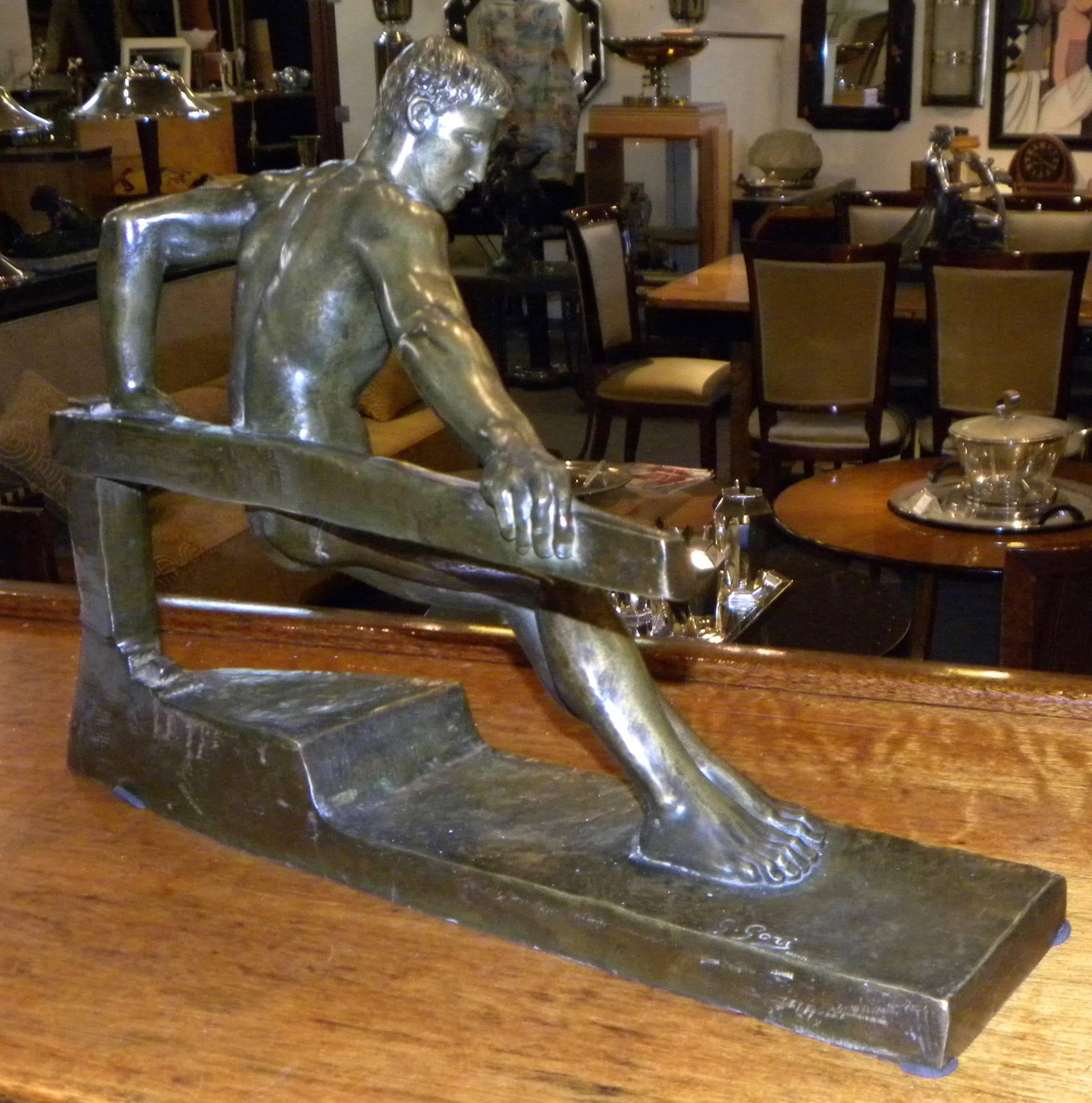 An Art Deco bronze sculpture by Georges Gori, depicting a man on a base that hints that it is a boat and he is pushing against a tiller to work the rudder against the power of the sea. There is exceptional detail in his face, hands and the