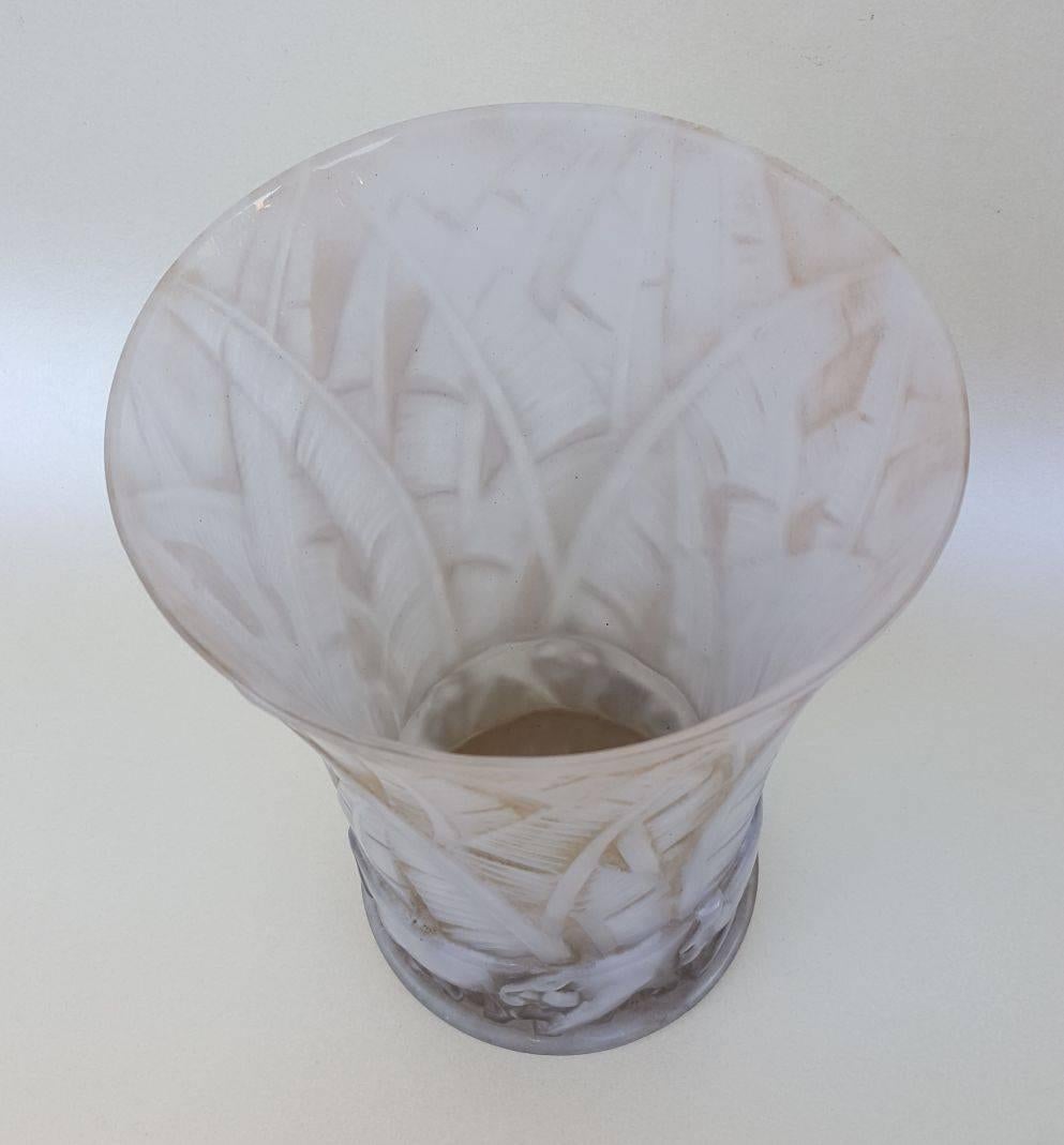 This Art Deco glass vase with tropical lion and leaf motif in high relief was created by Pierre D’Avesn circa 1930. It’s subtle use of Frost and the restrained use of color gives it a rich look and this is an “important” piece by a true master of