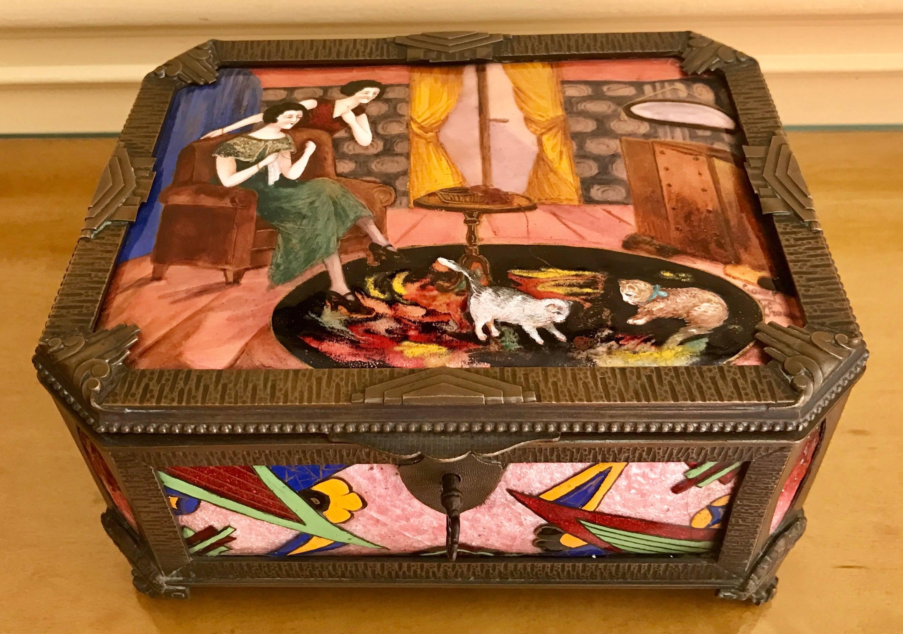 A large and impressive octagon shaped enamel dresser box, French, early 20th century and rendered in vibrant colors using five hand-painted and slightly convex porcelain panels. The custom hand-tooled bronze/brass frame with stylized chevrons and