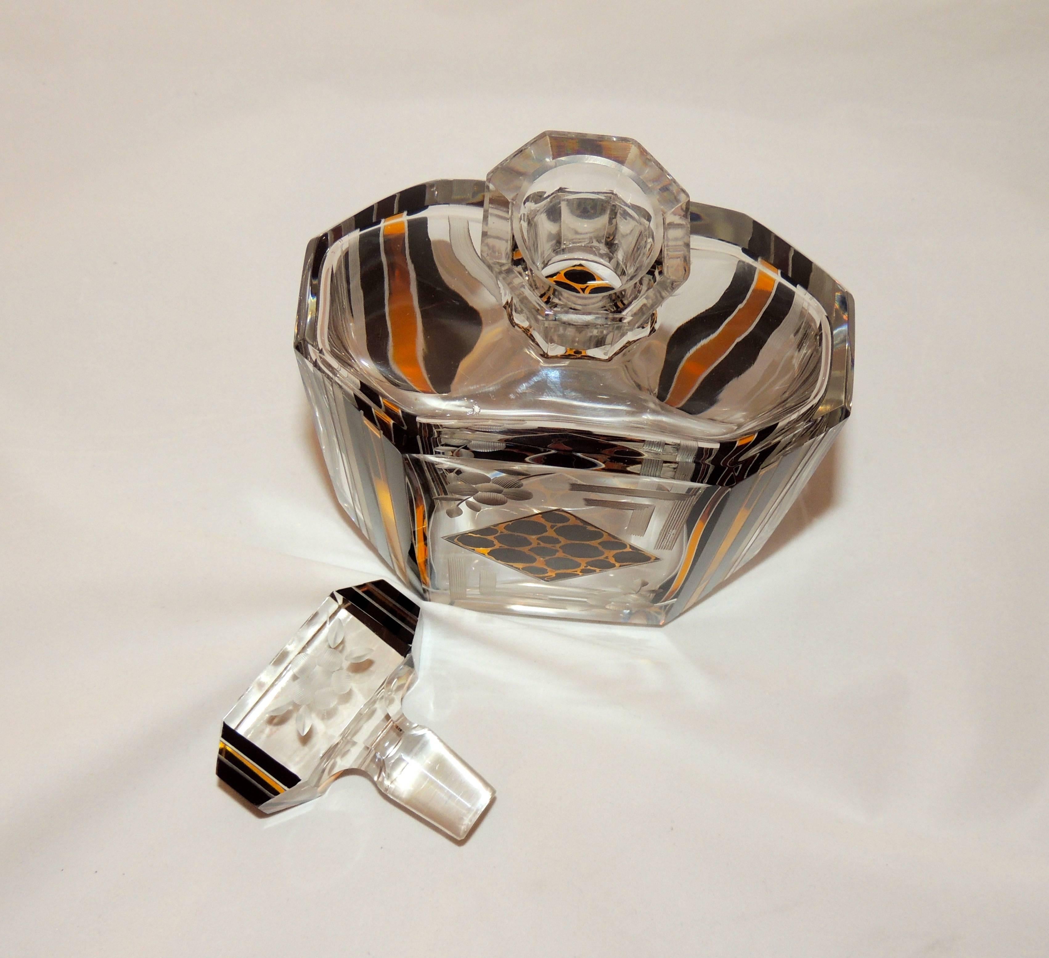 This Art Deco Czech Decanter set is a little bit wild with its leopard patterned detail but also delicately etched and Classic.

With its six matching glasses, two tone decoration and grand stopper that also carries through the color treatment, it