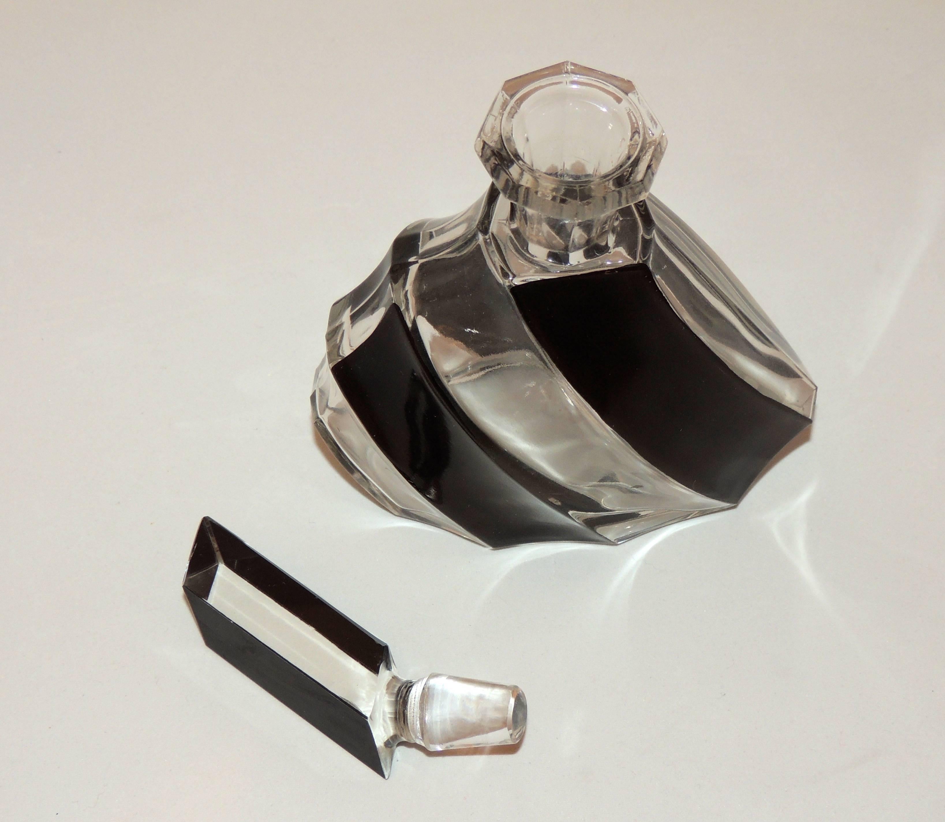 An Art Deco decanter set from Czechoslovakia with a bold modernist design and a stopper and glasses that lean to the left or the right (your choice). Rich black enamel is embedded in the cut crystal to form the design.

Each country had its