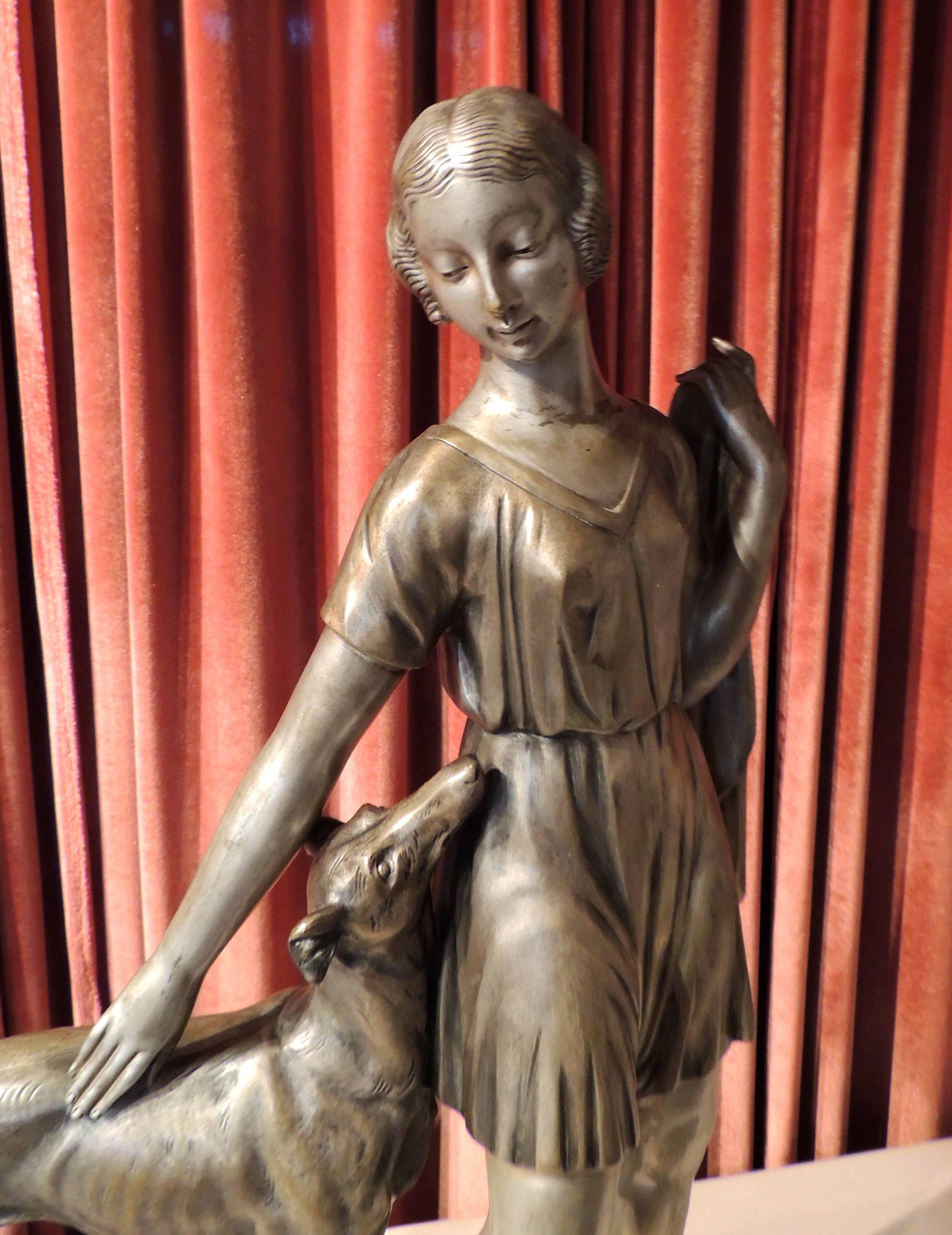 An iconic, large-scale bronze sculpture by Spanish artisit Ignacio Gallo depicting a sleek Art Deco woman…with an even “sleeker” Greyhound dog looking adoringly at his owner. It is a graceful pose, beautifully rendered. The base is a “sandwich” of