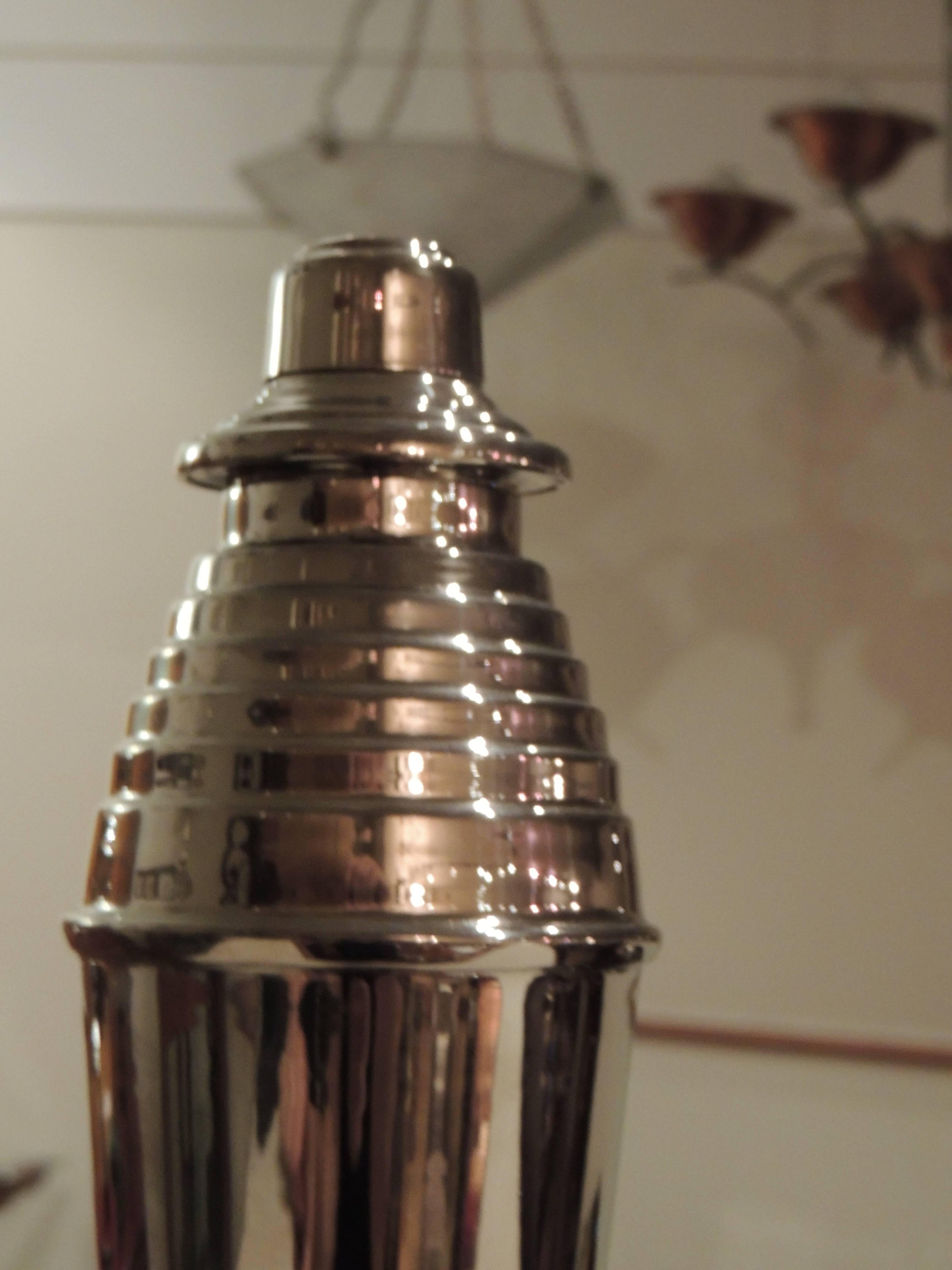 This great Art Deco cocktail shaker has the stepped up design that evokes the feeling of the Chrysler Building, of Flash Gordon, of rocket ships and of so many “futuristic” designs from that period. Nicely silver plated, with an unusual perforated