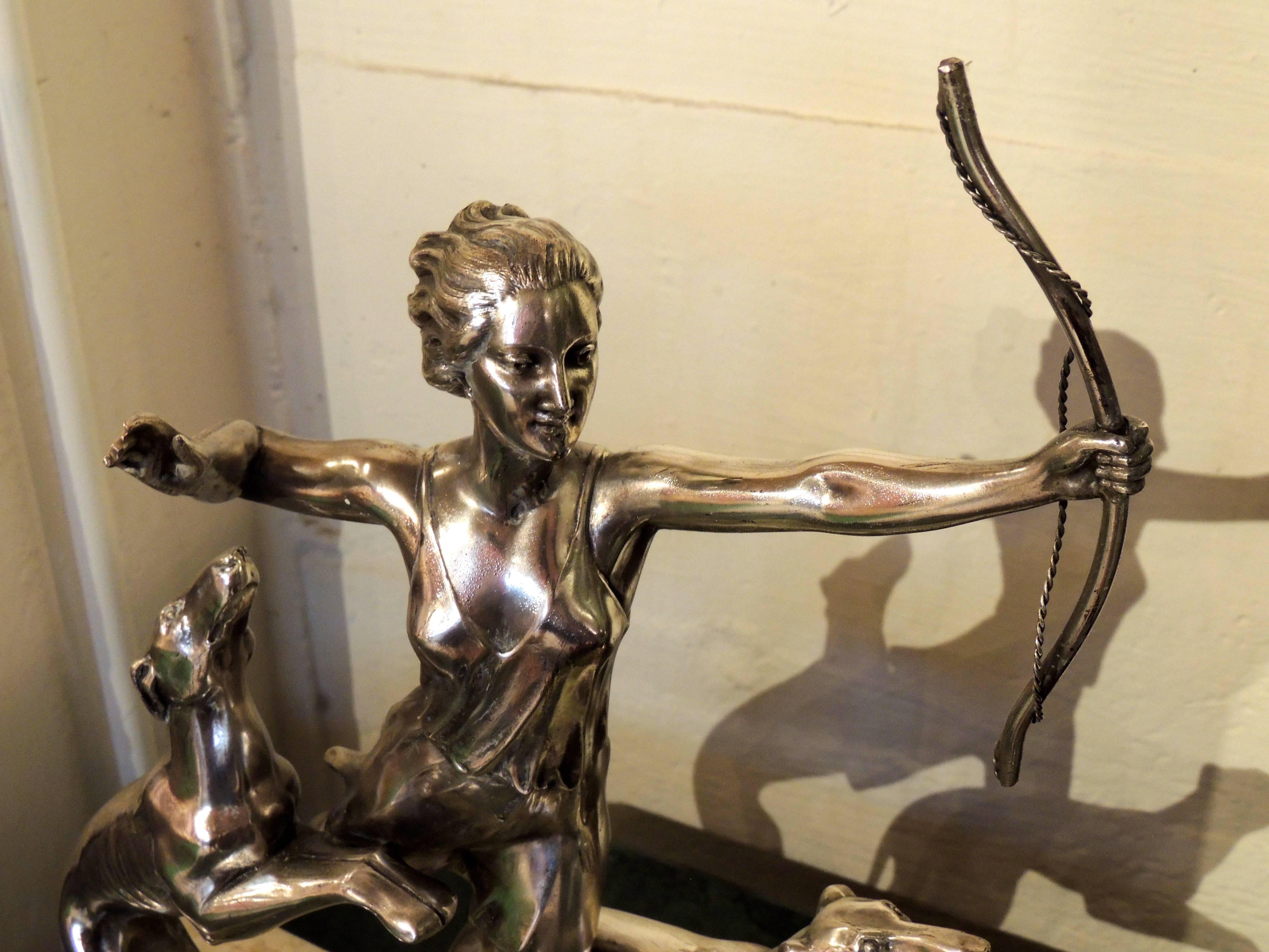 An Art Deco Icon , this image of Diana as a statue in silver on a two tone, layered marble base is one of the most graceful we have seen. The breeze gently ruffles her hair and tunic, her features and figure are well rendered. She is portrayed as a
