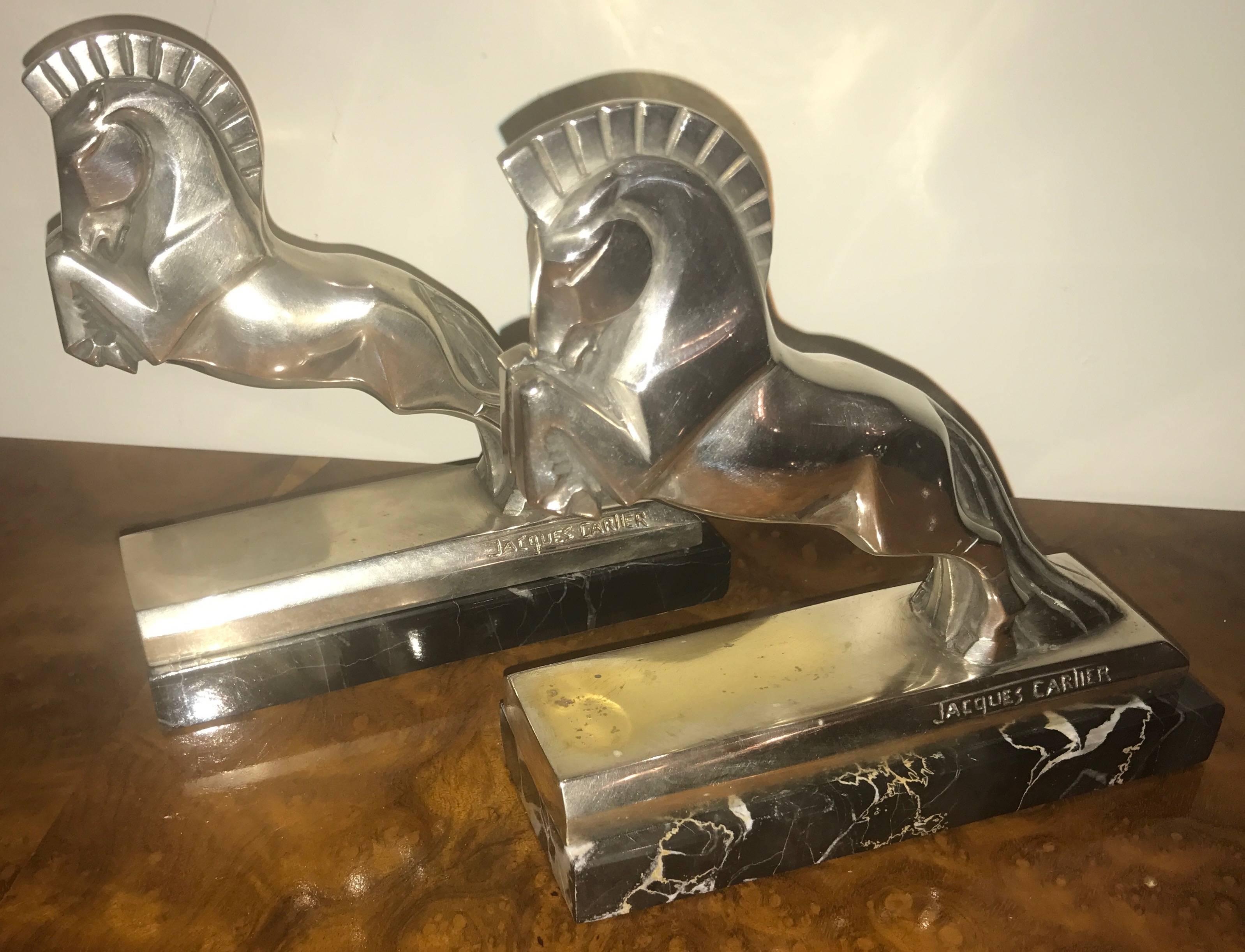 Silvered plated bronze Art Deco horse bookends by Jacques Cartier (French, 1907-2001). Both signed Jacques Cartier in lower area and both on a black marble base. Made in France, circa 1930. Cubist sculpture of an equestrian horse with bold mane.