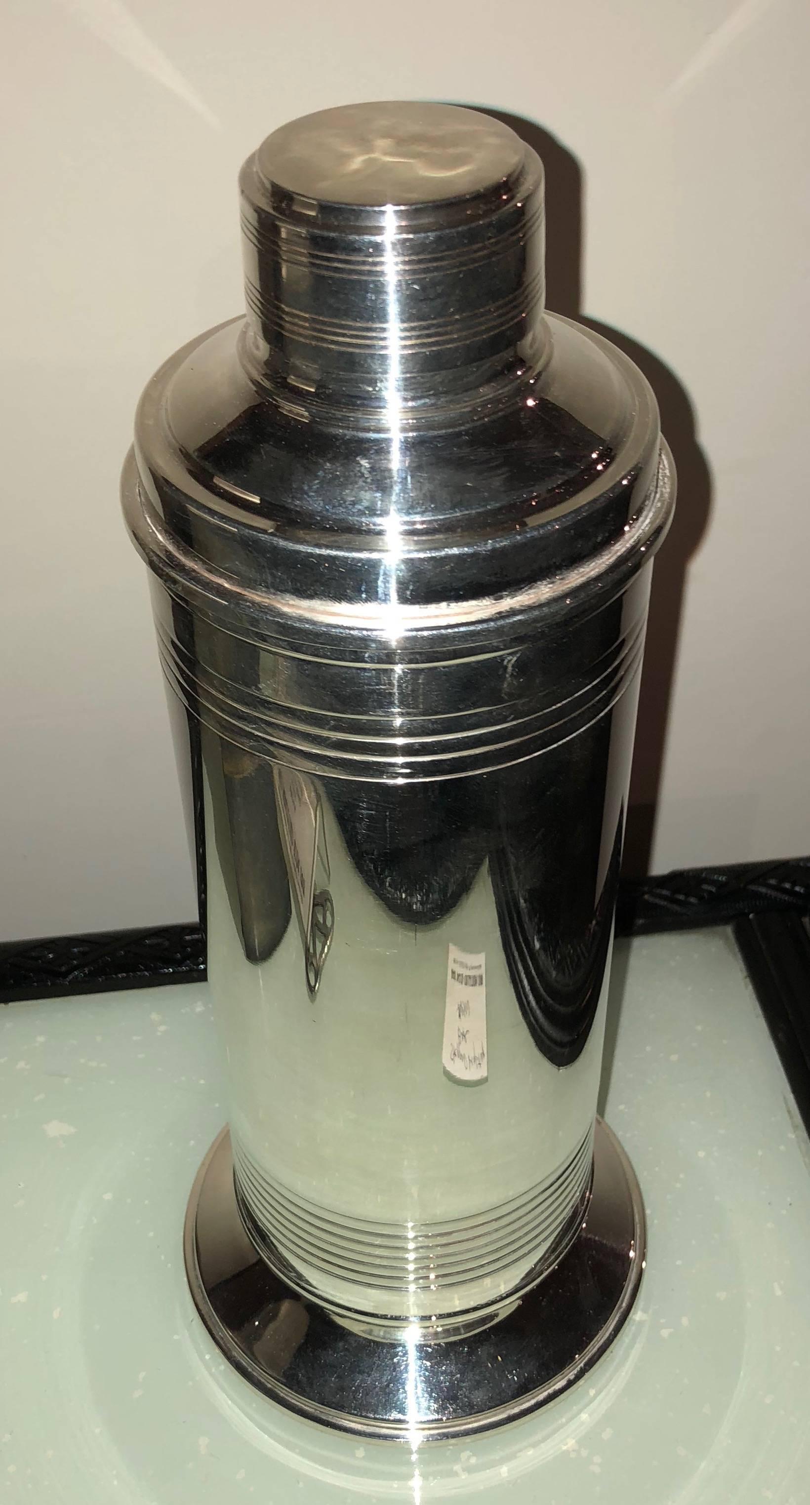 Modernist high quality English cocktail shaker in pristine restored condition. Unusual design with modern flair, concentric circle detail giving it a ribbed effect centered on a substantial footed based. Clear foundry marks on the bottom, certainly