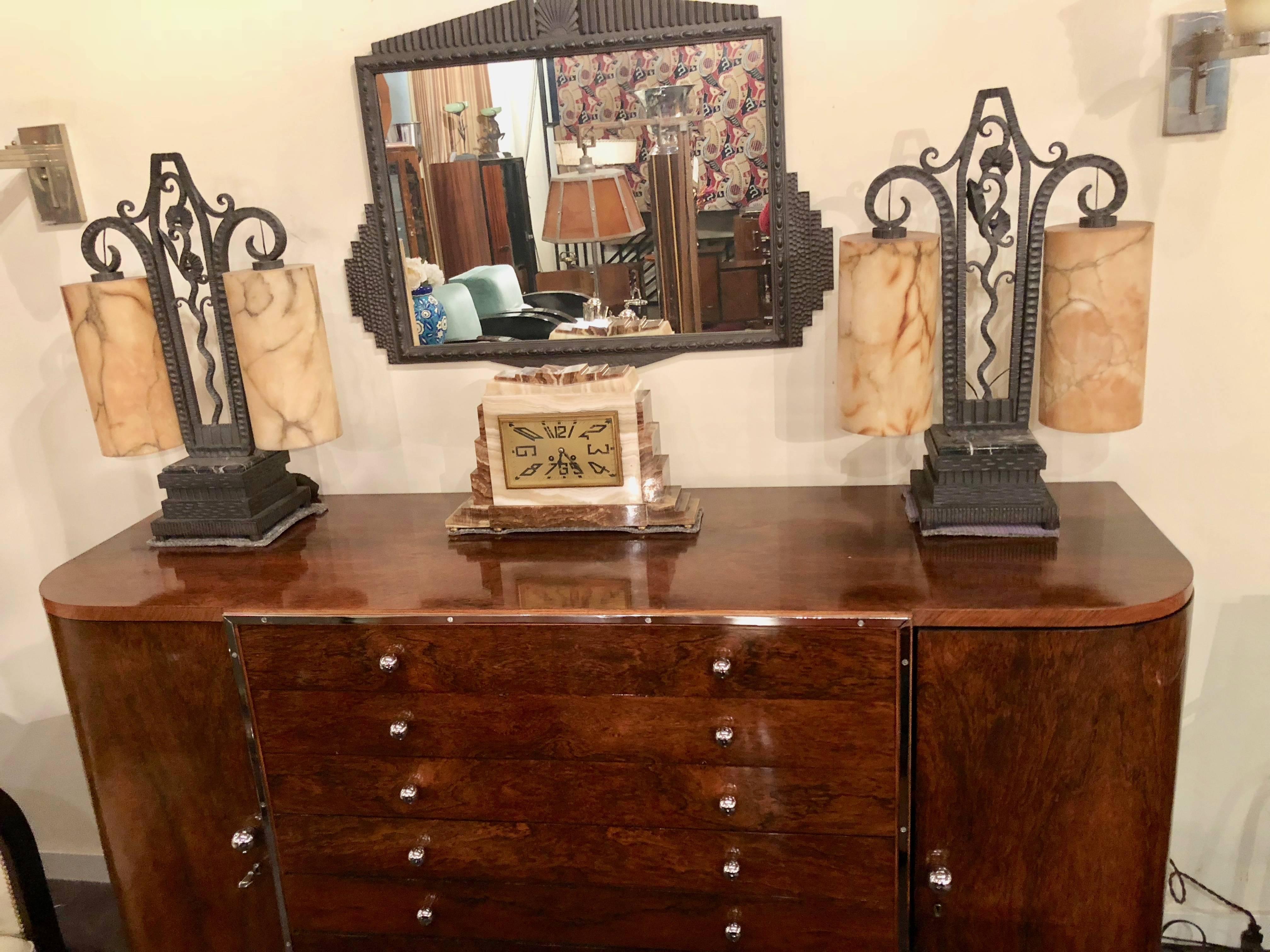 Stunning French Art Deco rosewood buffet cabinet. Modernist design, unusual treatment with multiple drawers all outlined in metal. Complimented using round metal storage pulls. Multiple drawers for dining room needs, silverware, table-cloths and