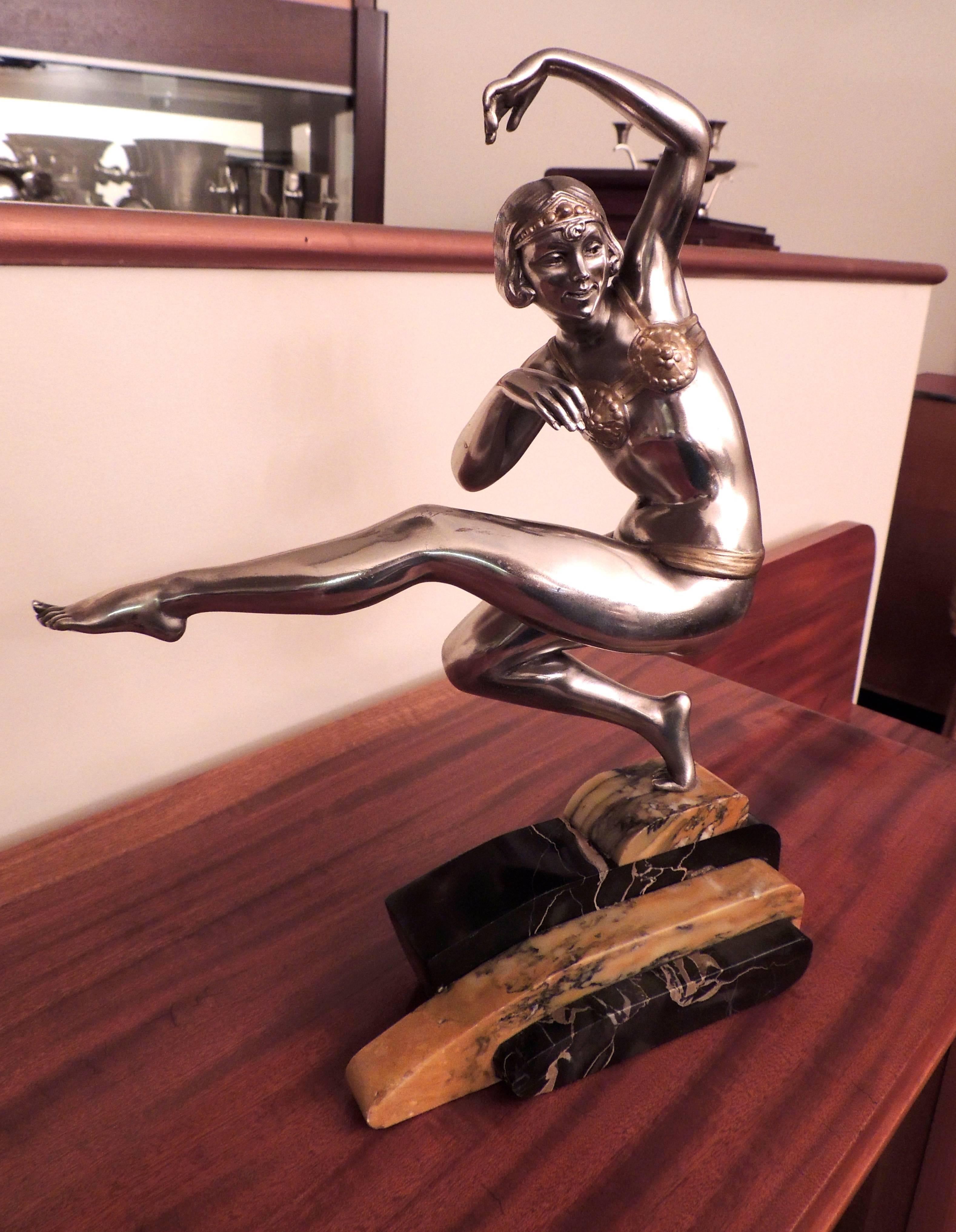 An Art Deco Harem dancer sculpture by Belgian artist Georges Abel Van de Voorde has wonderful features! A lovely face, a dynamic pose, interesting marble base, gleaming silvered patina with a light touch of gilding. It is the perfect table top