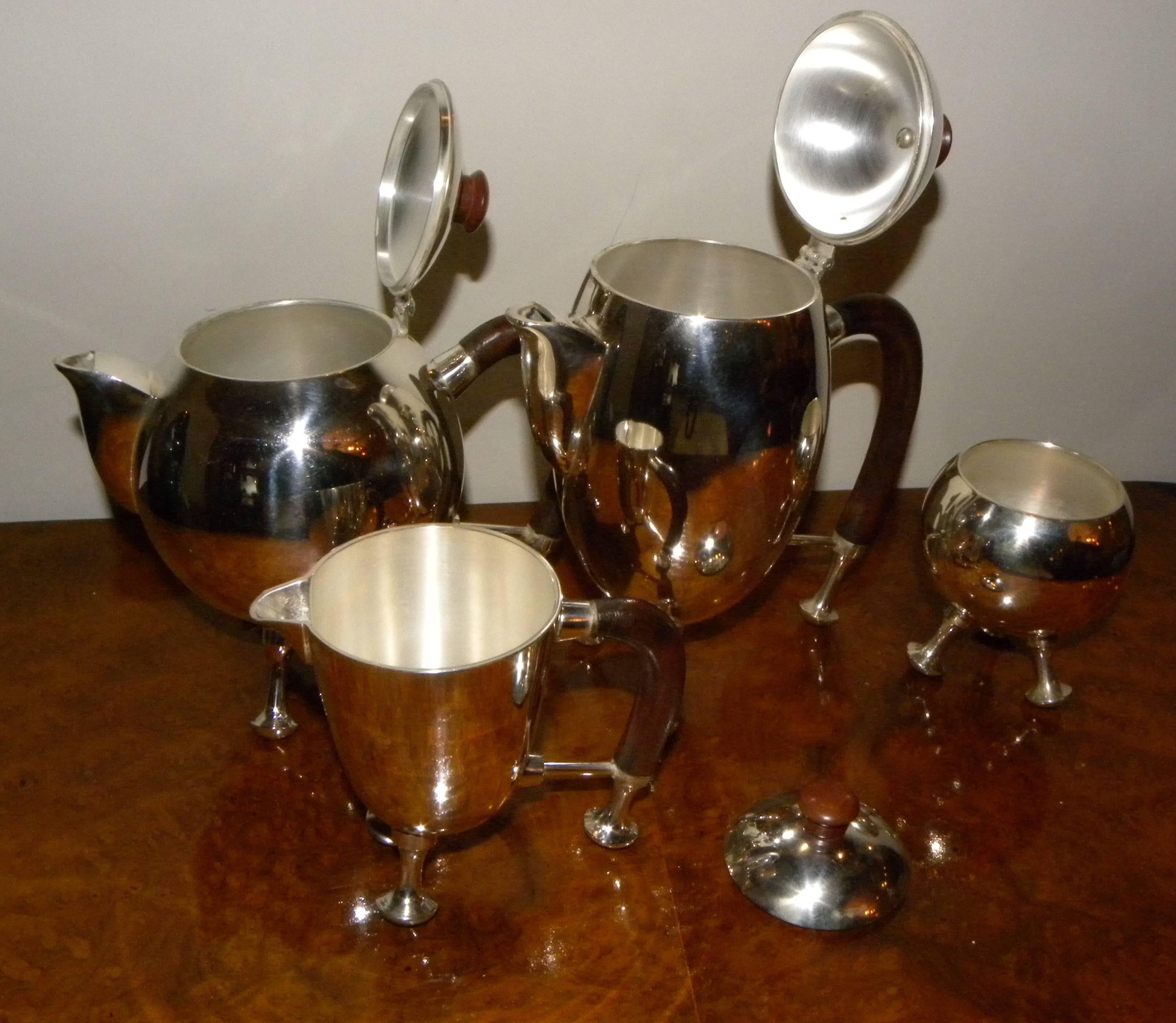 His wild, whimsical and somewhat “space age” silver tea and coffee set is one of the most unusual we have ever had. Curved wooden handles and pieces that rest on silver feet, it takes the formal and traditional coffee-tea-cream-and-sugar combination