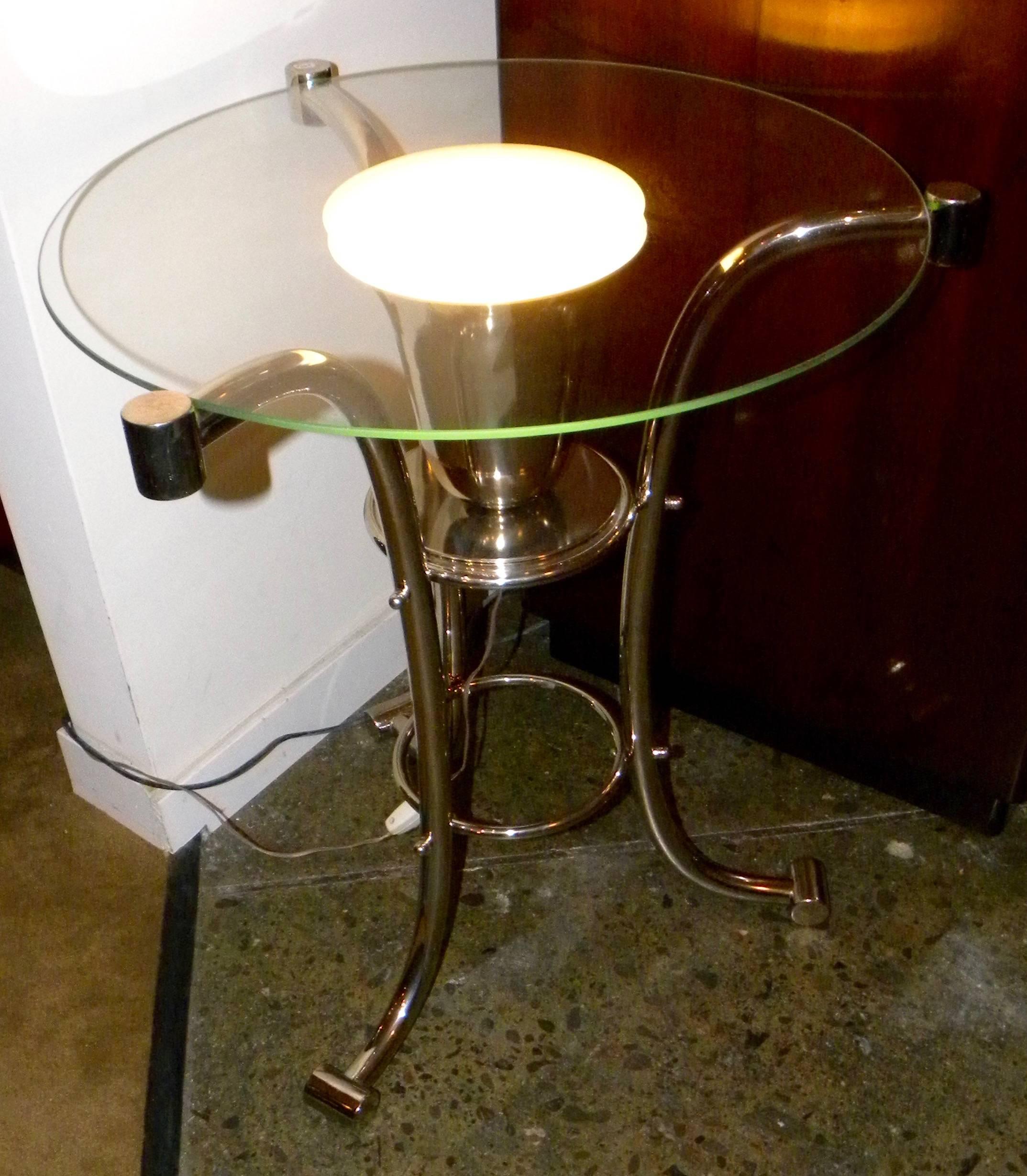 Unusual clear glass top round table with uplight. Nice metal frame with very Art Deco style. Would look great also in clean Mid-Century room. Frosted center circle which echoes the intensity of the uplight makes for a nice ambient light treatment.