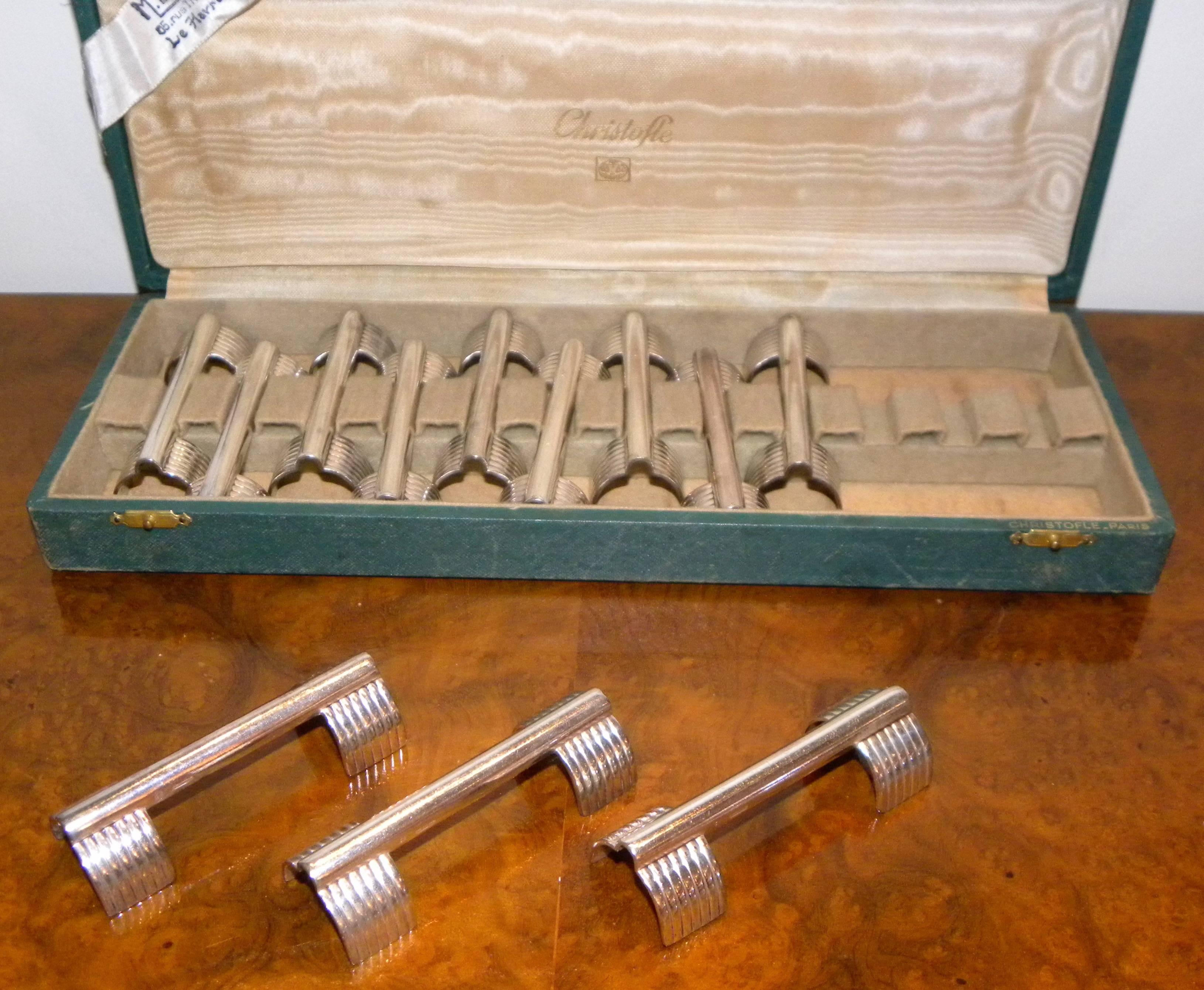 12 original Christofle knife rests complete in original box. This is a very modern design from the 1930s attributed to Luc Lanel who did so much of the most memorial and collectible tableware for Christofle during this period.

The design is