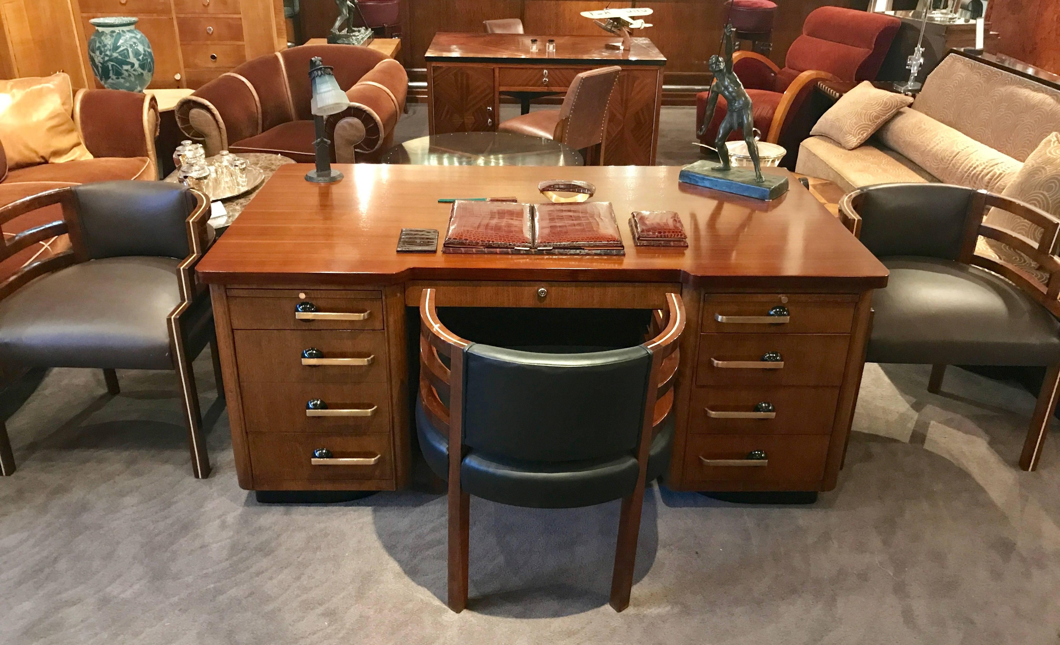 Executive Art Deco desk, extremely well made in America (Grand Rapids, Michigan) by Stow & Davis. Twin pedestal bases with a complimentary top, echoes the Classic shape. Very nice mahogany veneers and lots of drawers for just about everything:
