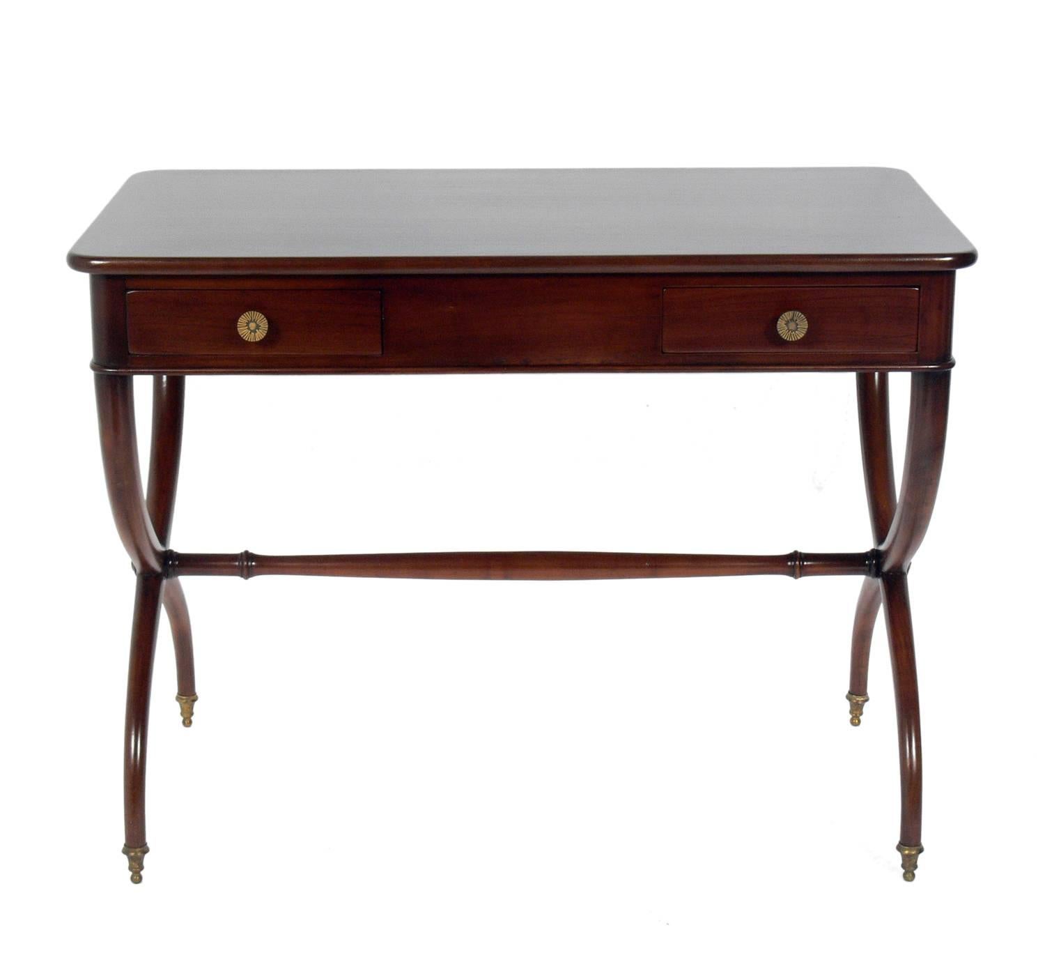 French Art Deco desk with curvaceous X-base, French, circa 1930s. It has been refinished and is ready to use. Retains brass tag in interior of drawer which reads 