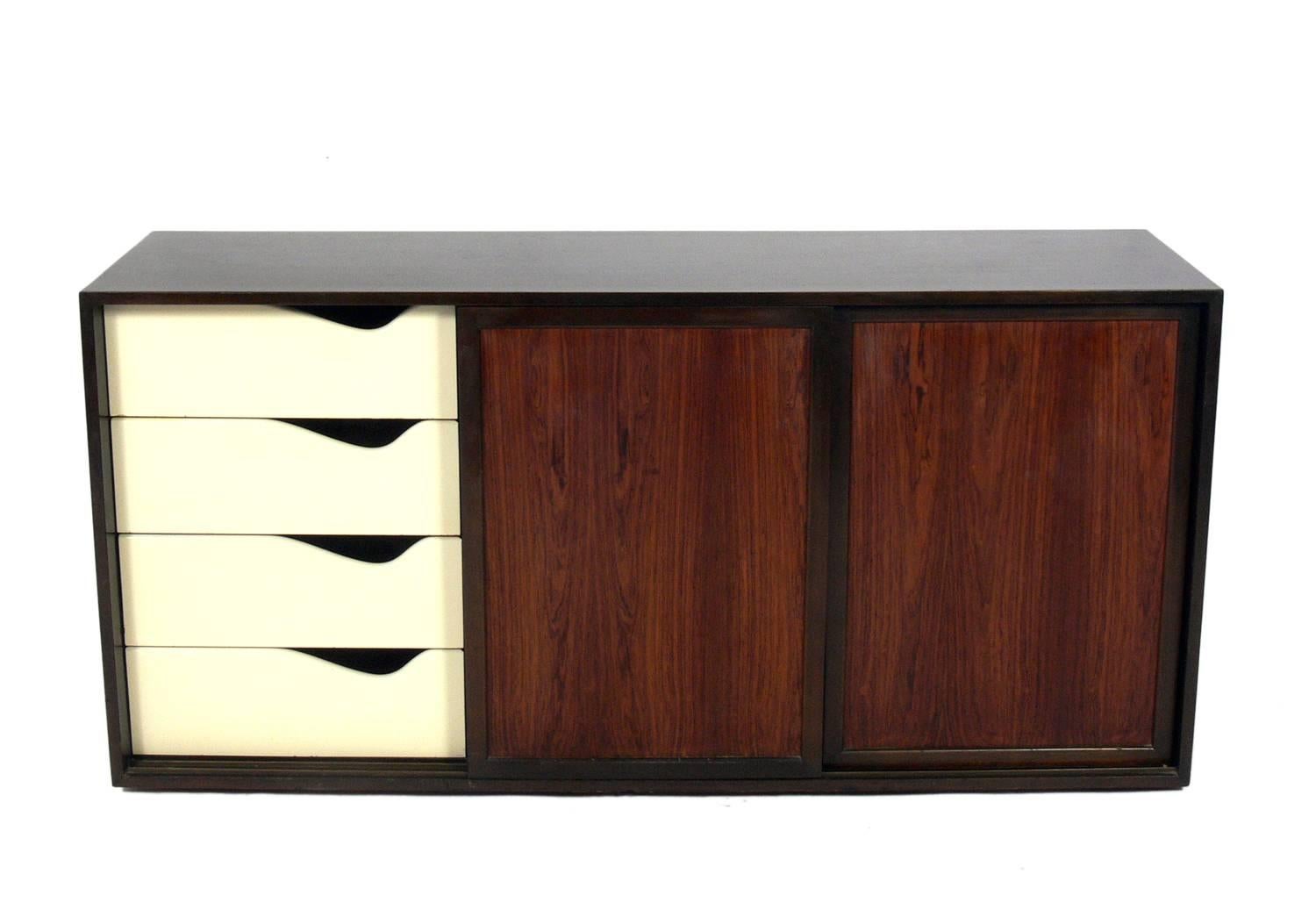 Modern rosewood chest or credenza, designed by Harvey Probber, American, circa 1960s. It is a versatile size and can be used as a credenza, cabinet, or bar in a living area, or as a chest or dresser in a bedroom. It offers a voluminous amount of