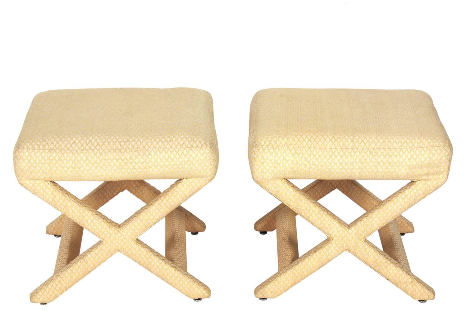 Pair of upholstered X-stools, American, circa 1960s. They retain their original fabric. The fabric has some faint spots and can be used as is, or we can reupholster them in your fabric for an additional $500 for the pair.