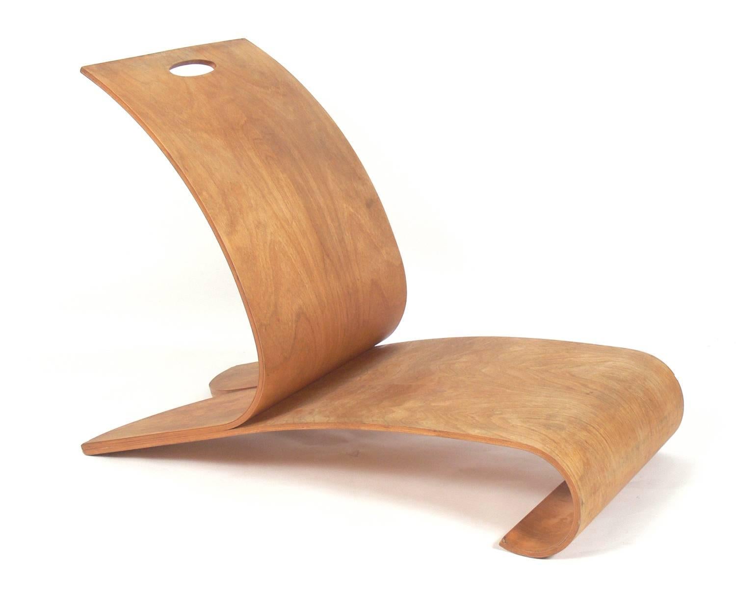 Curvaceous bentwood lounge chair, American, circa 2000s. Cuvaceous low slung form constructed of molded plywood. Artist signed on the bottom.