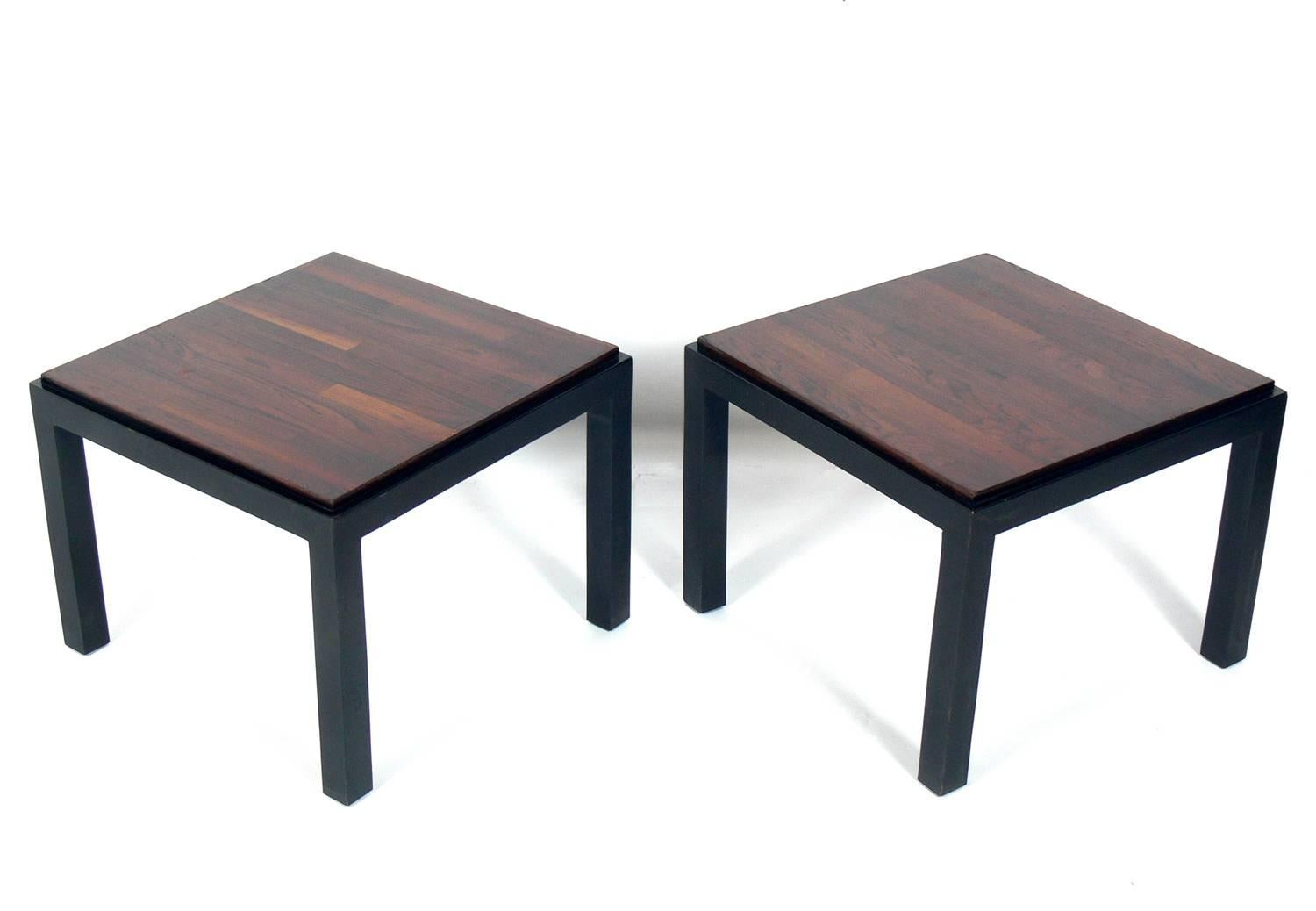 Pair of rosewood and black lacquer end tables, designed by Milo Baughman for Thayer Coggin, American, circa 1960s. They are a versatile size and can be used as side or end tables in a living area, or as nightstands in a bedroom.
