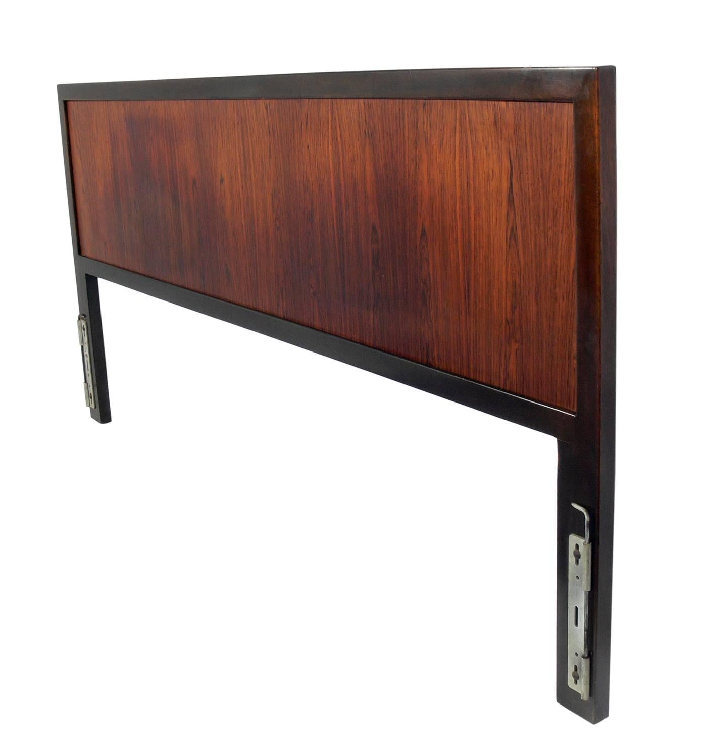 Clean lined rosewood and mahogany headboard, designed by Harvey Probber, American, circa 1960s. This piece is currently being refinished and will look incredible when it's completed. This headboard fits a king-size US mattress and can be used with a