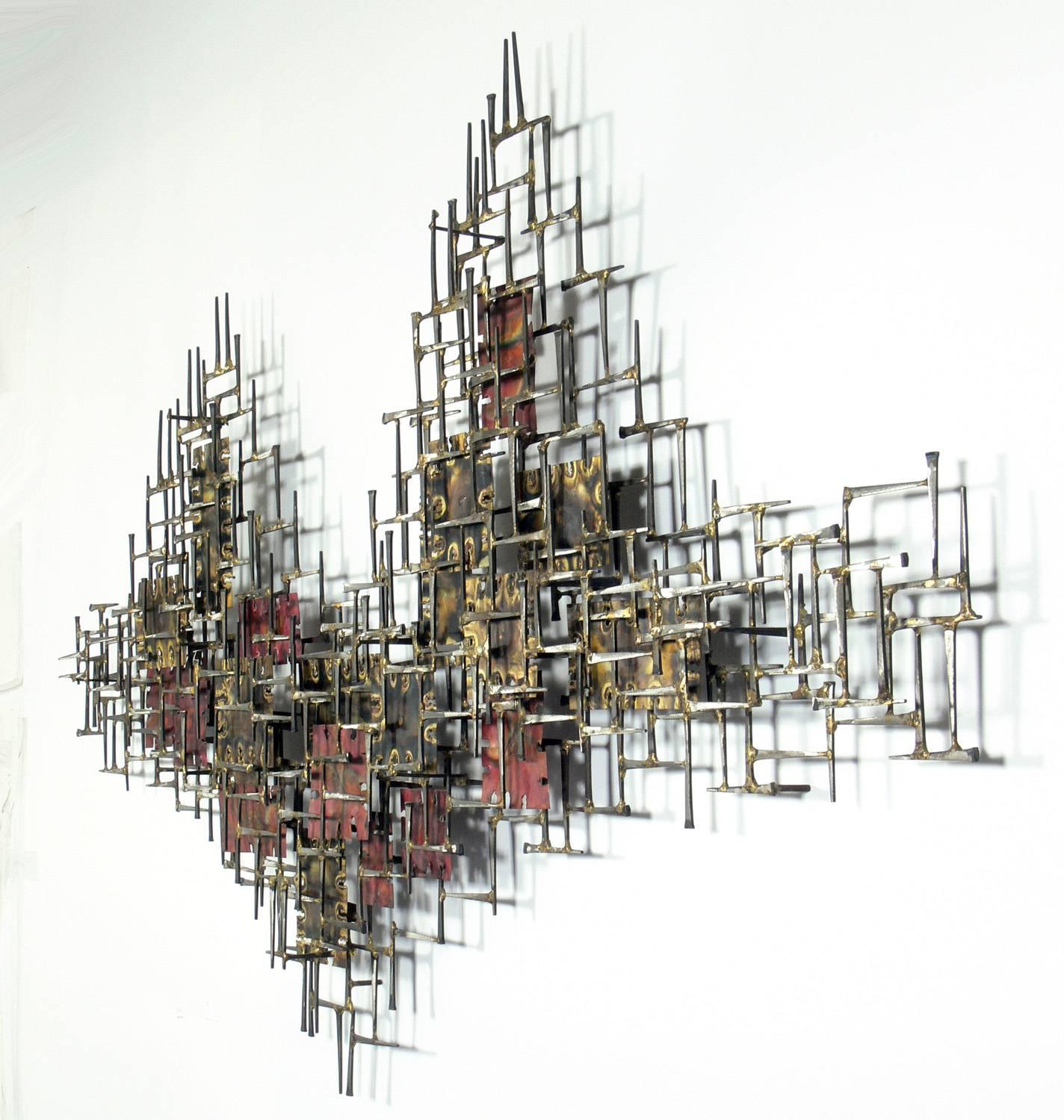 Large-scale abstract wall sculpture handmade by Silas Seandel, American, circa 1980s. Signed by the artist on a plaque on the verso. Retains warm original patina.
