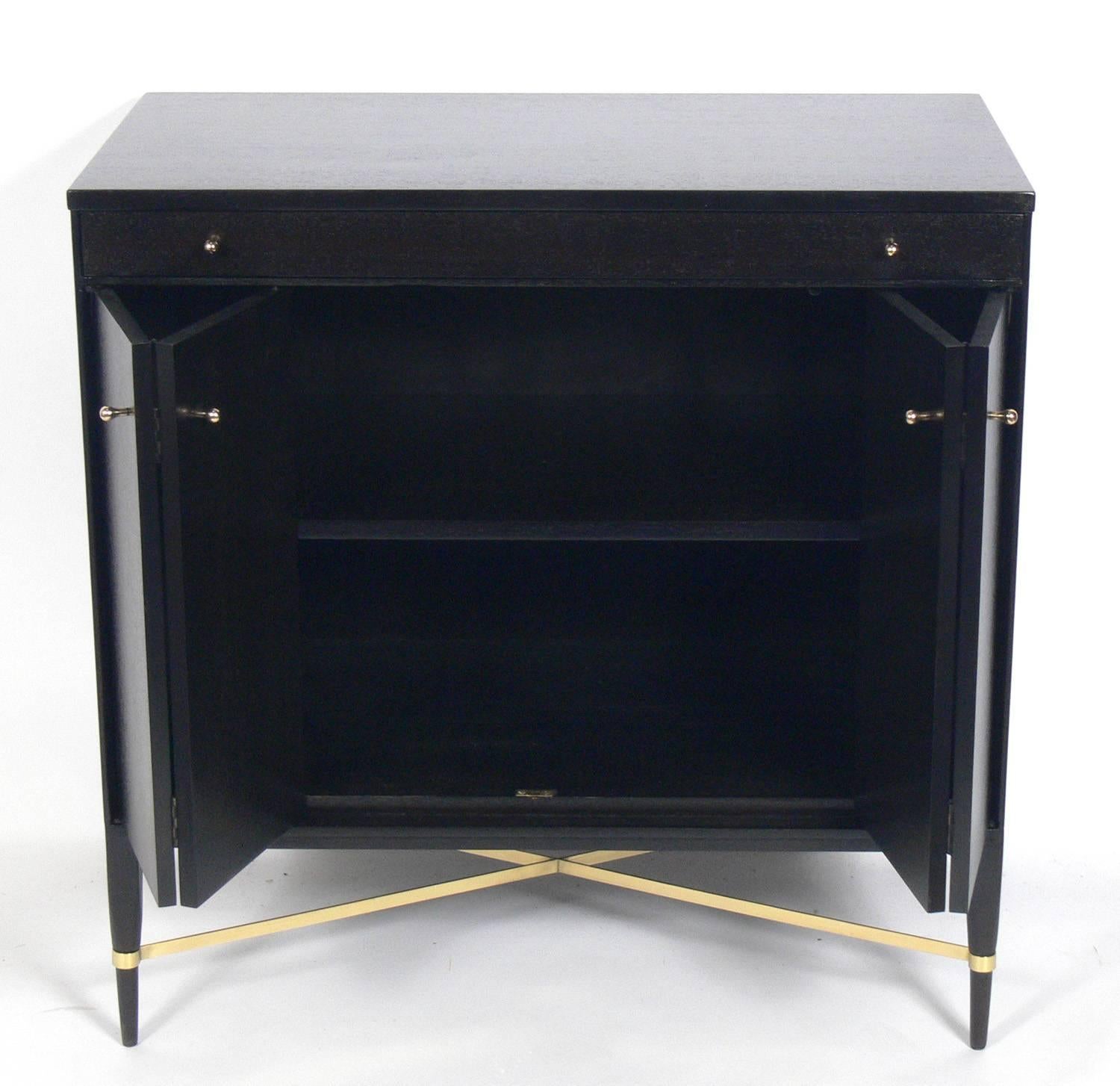 Mid-Century Modern cabinet, designed by Paul McCobb for Calvin, American, circa 1950s. It has been completely restored in an ultra deep brown color with the brass hardware polished and lacquered. It is a versatile size and can be used as a credenza,