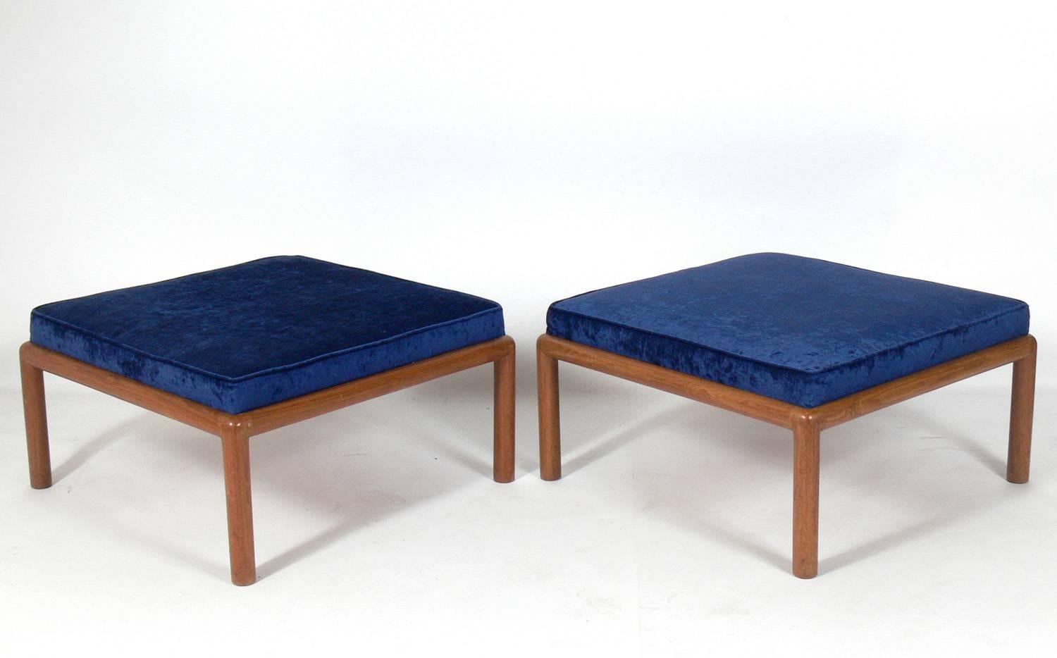 Pair of ottomans, stools or benches, attributed to T.H. Robsjohn-Gibbings, American, circa 1950s. They have been reupholstered in a velvety indigo blue fabric.
 