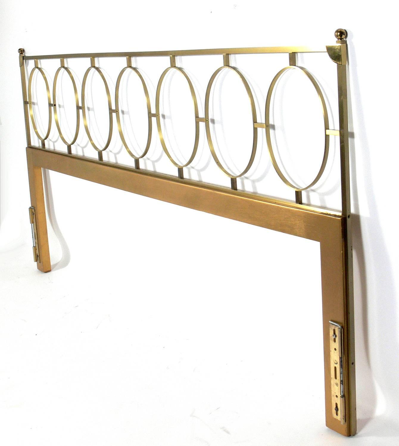 Glamorous brass headboard for a king-size bed, American, circa 1960s. Retains it's warm original patina. Works with most standard bolt on bed frames (not included).