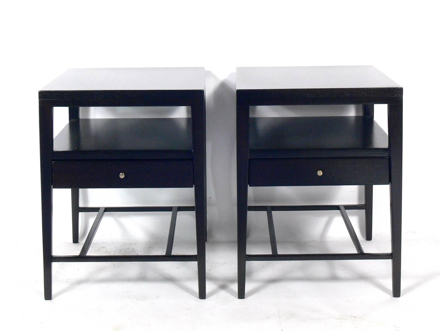 Pair of Clean Lined Night Stands or Side Tables, designed by Paul McCobb for Calvin, American, circa 1950s. They have been completely restored in an ultra deep brown color and the brass hardware has been polished and lacquered.