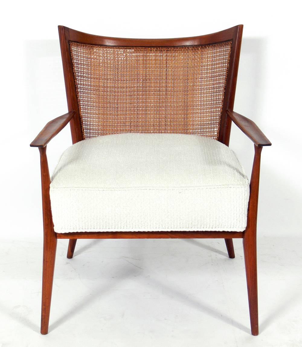 Curvaceous caned back lounge chair by Paul McCobb, American, circa 1950s.