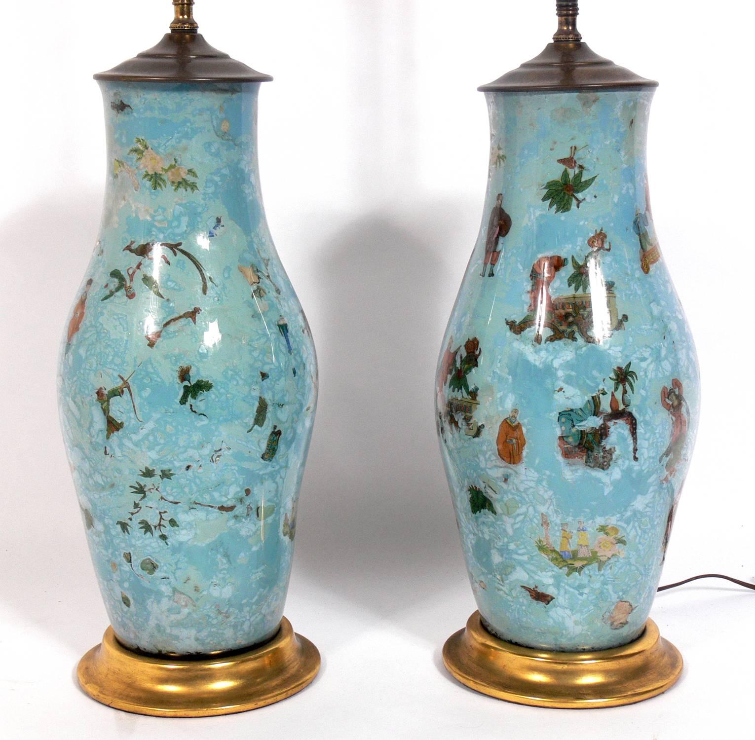 Pair of Robin's Egg Blue Asian Influenced Lamps, probably American, circa 1950s. They are constructed of reverse painted glass with Asian decorations on the interior of the glass and brass fittings. They have been rewired and are ready to use. The