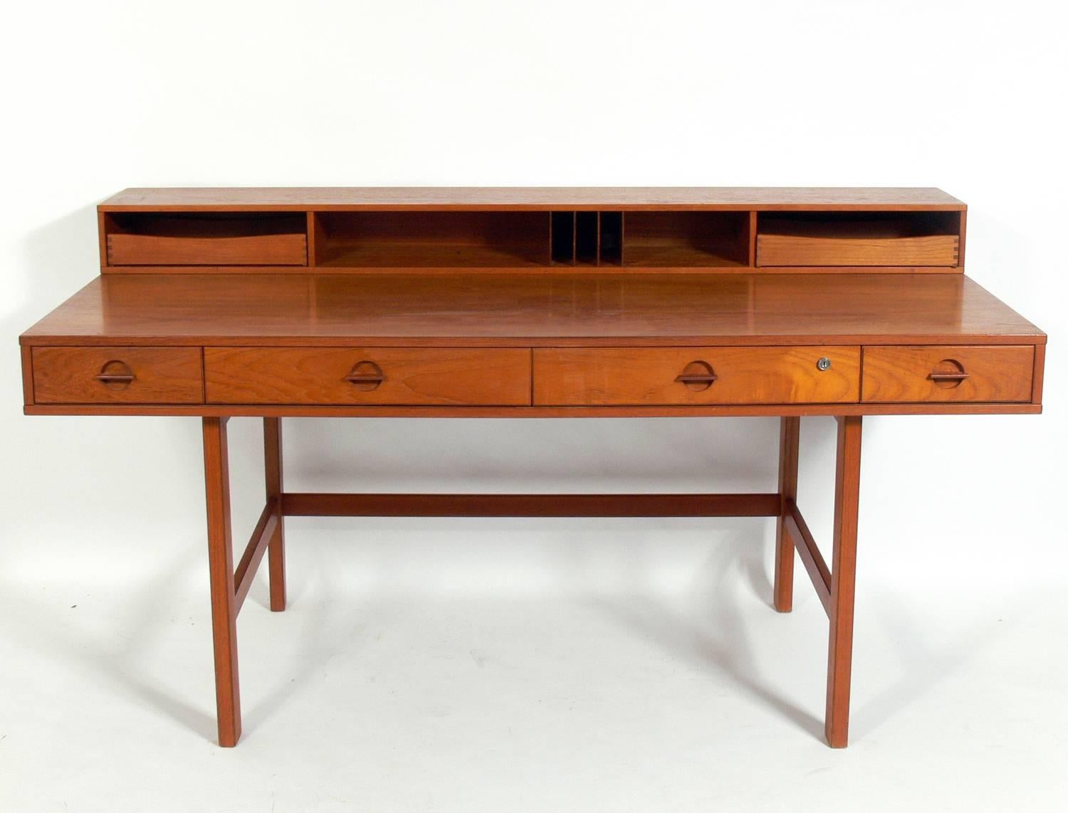Clean lined architectural Danish modern desk by Jens Quistgaard for Løvig, Denmark, circa 1960s. This desk is currently being refinished and will look incredible when it is completed. We do not have the key to the original lock, if you prefer, we