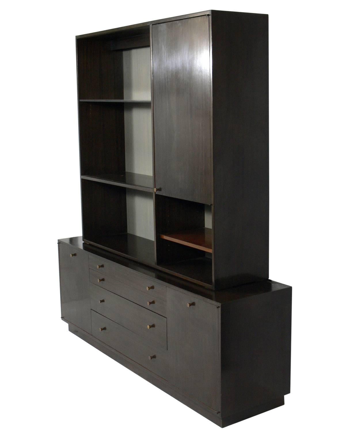 Elegant two-part cabinet or credenza, designed by Harvey Probber, circa 1960s. This piece is a versatile size and can be used as a vitrine, display cabinet, credenza, bar, or bookshelf in a living area, or as a chest or dresser in a bedroom. It