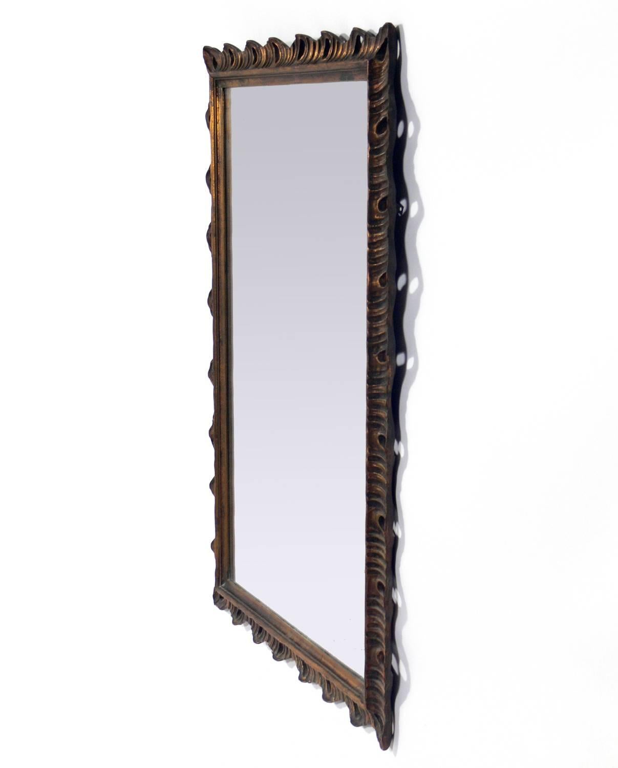 Gilt scalloped mirror, probably Italian, circa 1940s. Retains it's warm original patina to the gilt wood frame and the mirror.