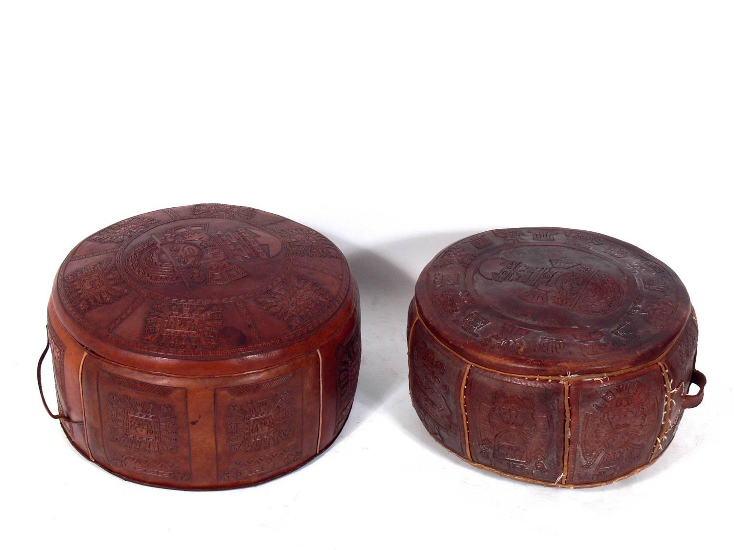 Mexican Tribal decoration leather stools, probably, circa 1950s. They are a versatile size and can be used as stools, ottomans, or poufs, or with the addition of a tray or top, could also be used as coffee tables. They retain their warm original