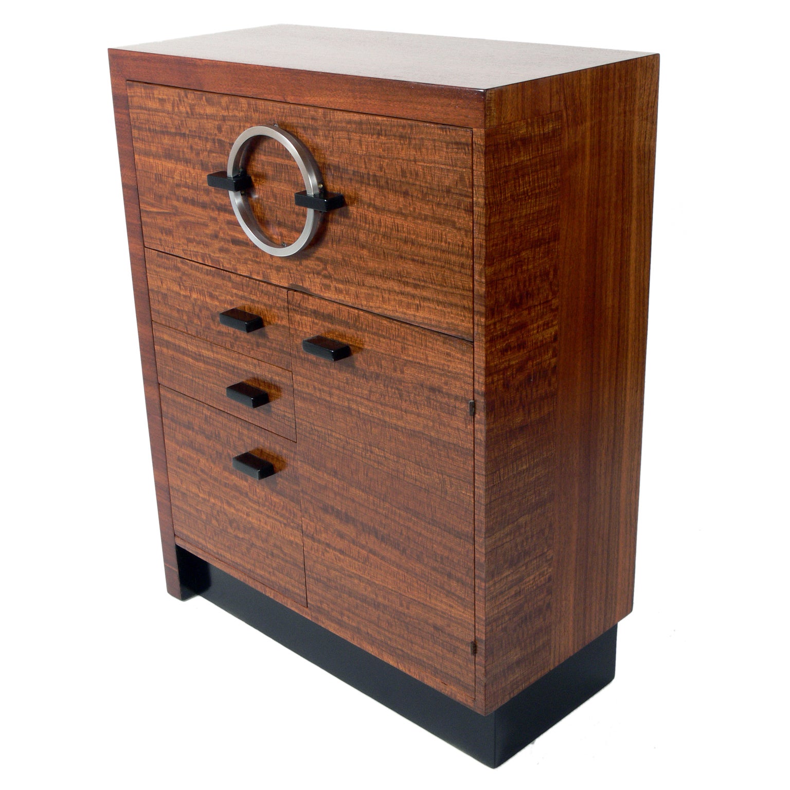 Modernist cabinet, designed by Gilbert Rohde for Herman Miller, circa 1930s. Constructed of exotic East Indian laurel wood with black lacquered trim and nickel plated metal hardware. This is a versatile pieces and can be used as a desk, cabinet,