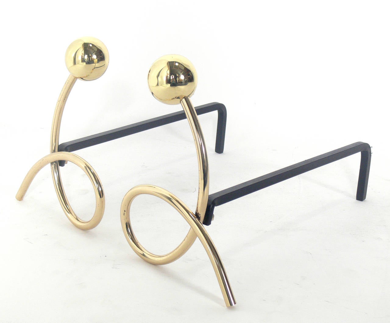 Whimsical brass loop andirons, in the manner of Jean Royère, circa 1950s. Hand polished and lacquered.