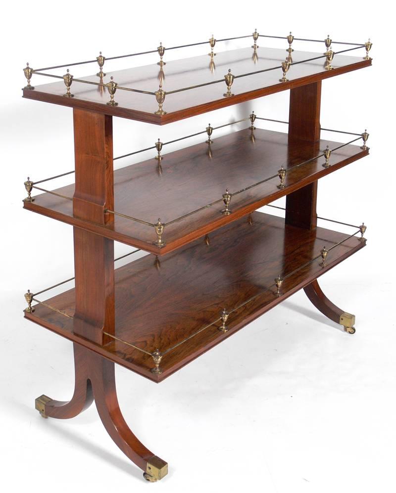 Rosewood and Brass Serving Cart, circa 1940's, possibly earlier. The rosewood shows beautiful graining and the brass retains it's warm original patina. This piece is a versatile size and can be used as a bar or serving cart, or as convenient rolling