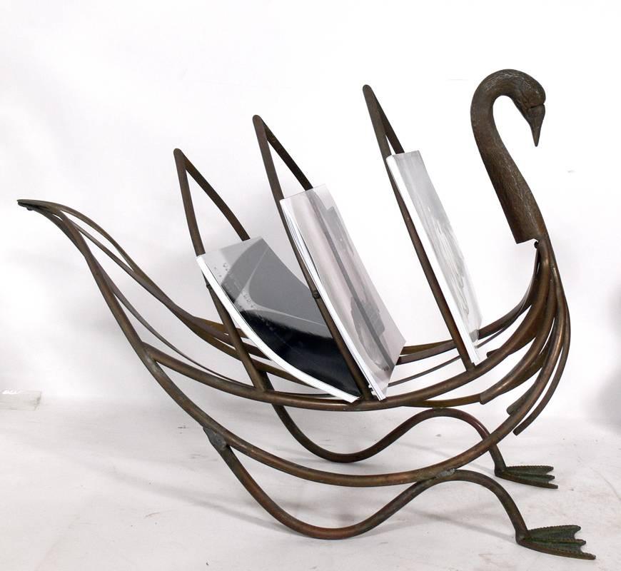 Selection of Magazine Racks, circa 1950's. From left to right, they are:
1) Italian brass swan magazine stand, circa 1950's. It measures 19.5