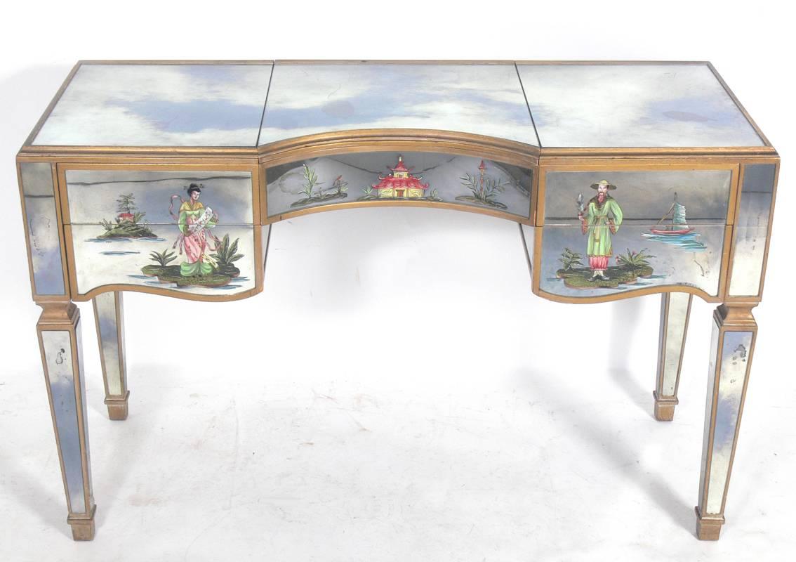 Elegant Mirrored Vanity, American, circa 1940's. It retains it's original hand painted Asian designs on the drawer fronts. It is a versatile size and can be used as a vanity, desk, or console table.