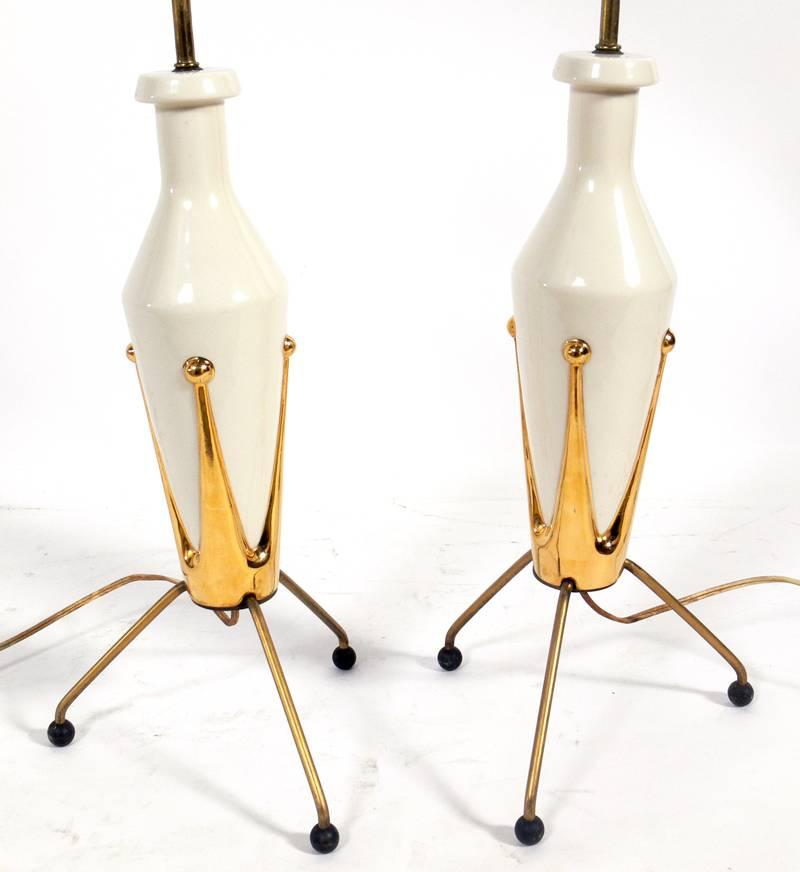 Pair of Mid Century Ceramic Tripod Lamps, American, circa 1950's. They have been rewired and are ready to use. The price noted below includes the shades.