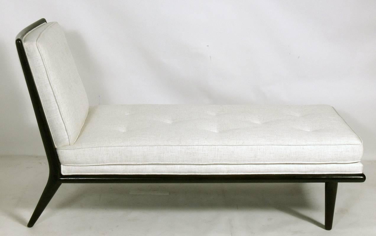 Modernist chaise lounge, designed by T.H. Robsjohn Gibbings for Widdicomb, circa 1950s. It has been completely restored in an ivory herringbone fabric and the walnut frame has been refinished in an ultra-deep brown lacquer.