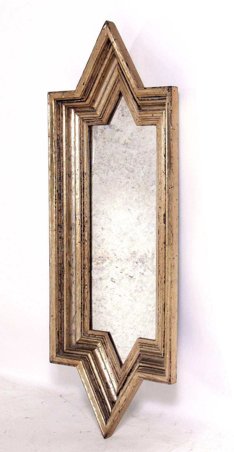 Angular silver leafed mirror, believed to be American, circa 1960s. Warm original patina to both the antiqued mirrored glass and the silver leafed frame.